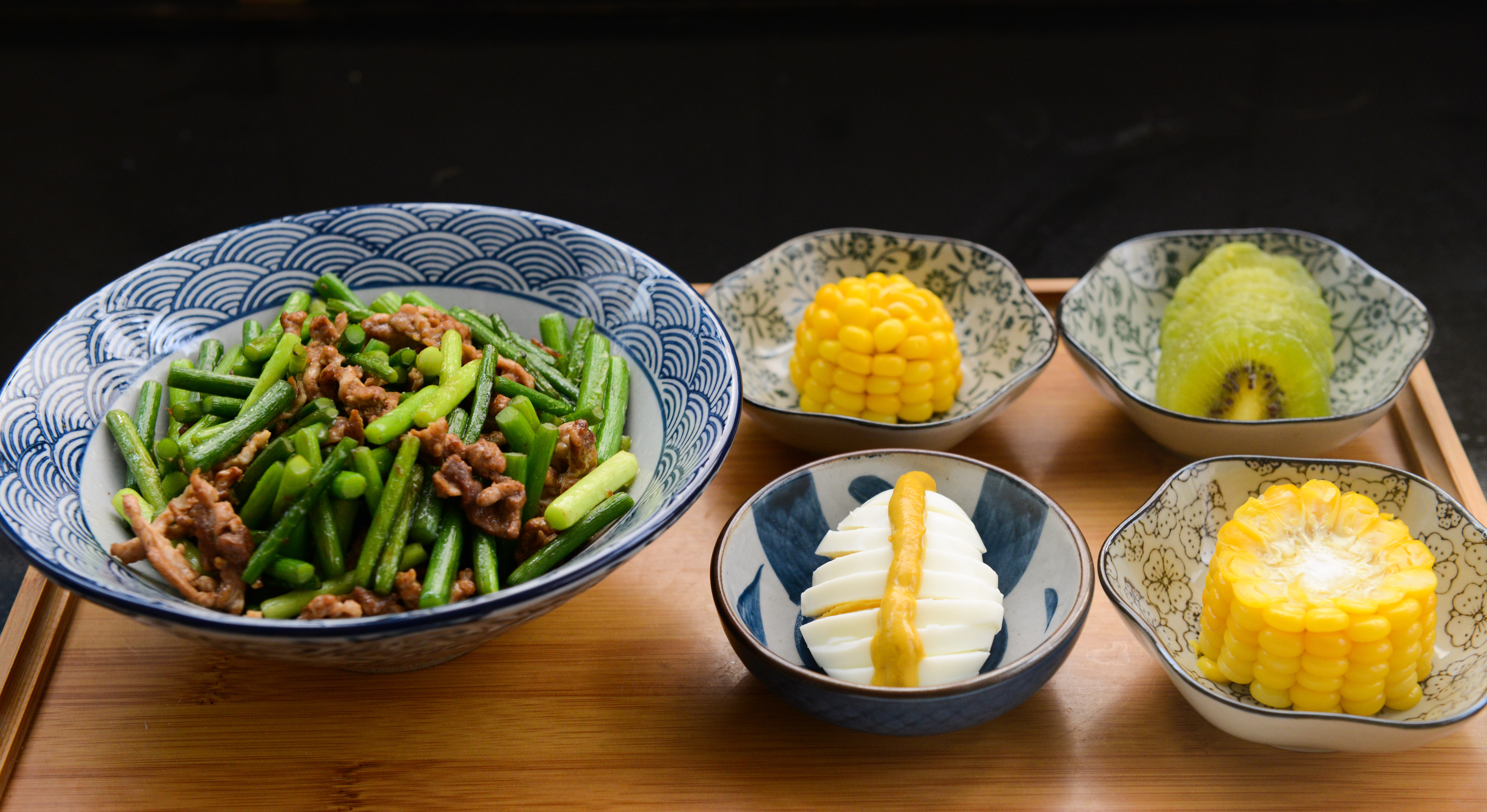 Egg, corn, kiwi with bowls photo
