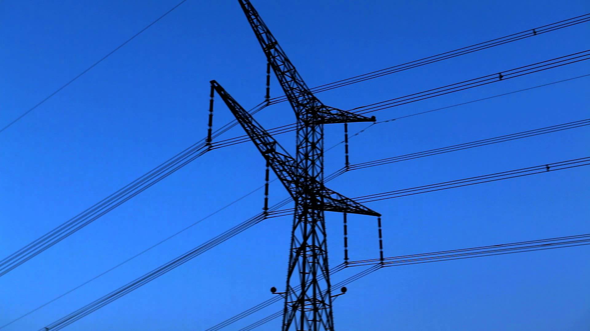 Stock Footage of a tower and power lines against the blue sky in ...