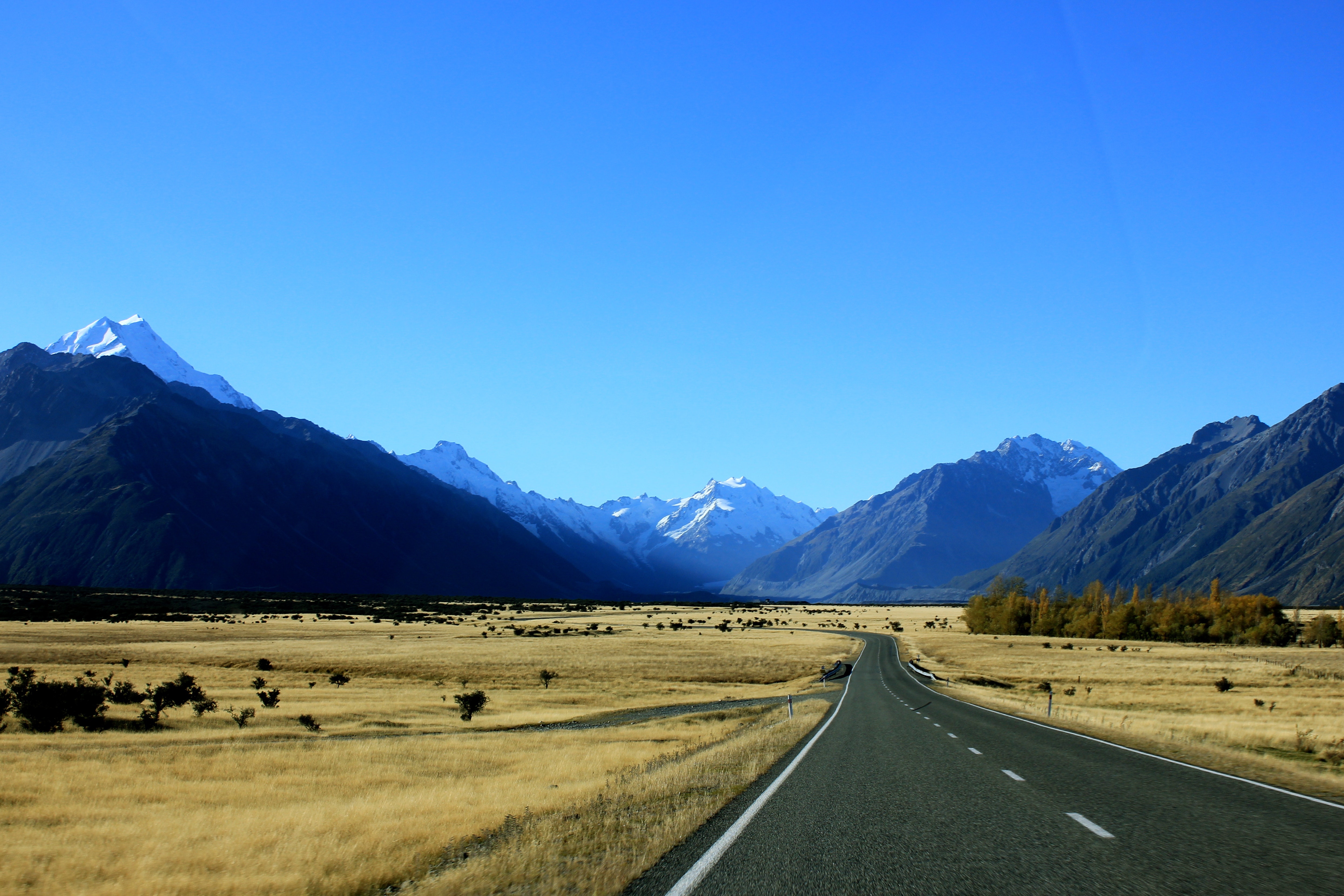 Empty road near mountain under blue skies photo