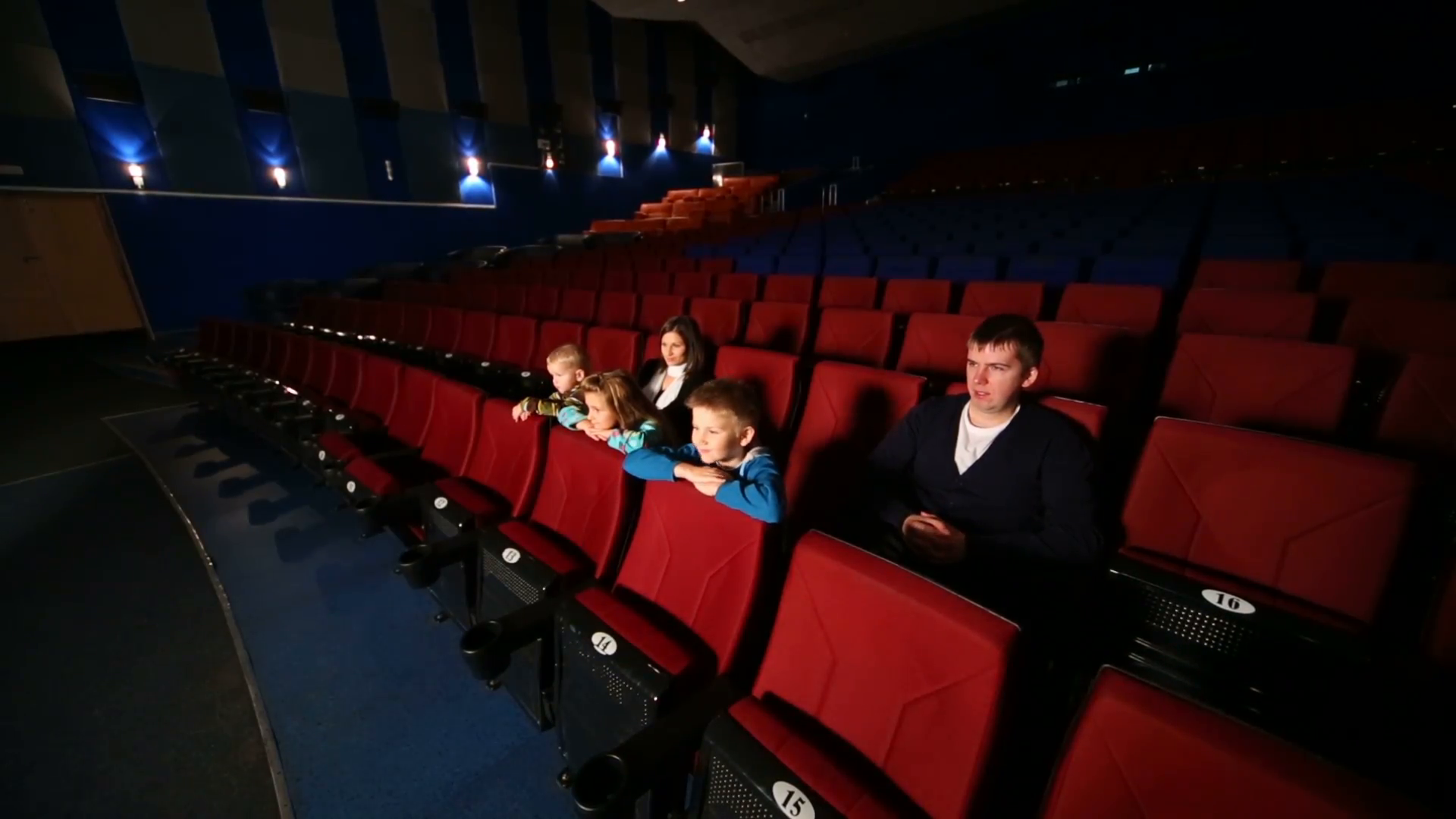 Family of five in a large empty cinema hall watching a movie Stock ...