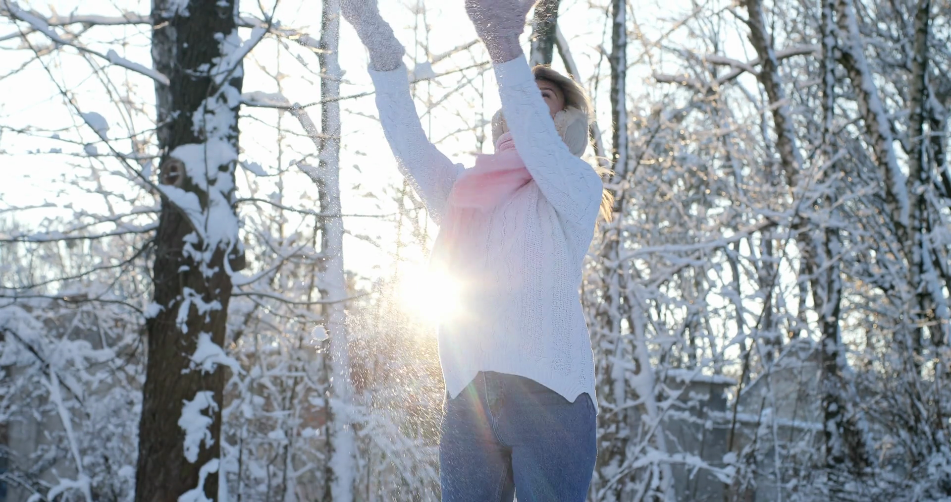 Woman in a park is happy about throwing snow. Happy winter time in ...