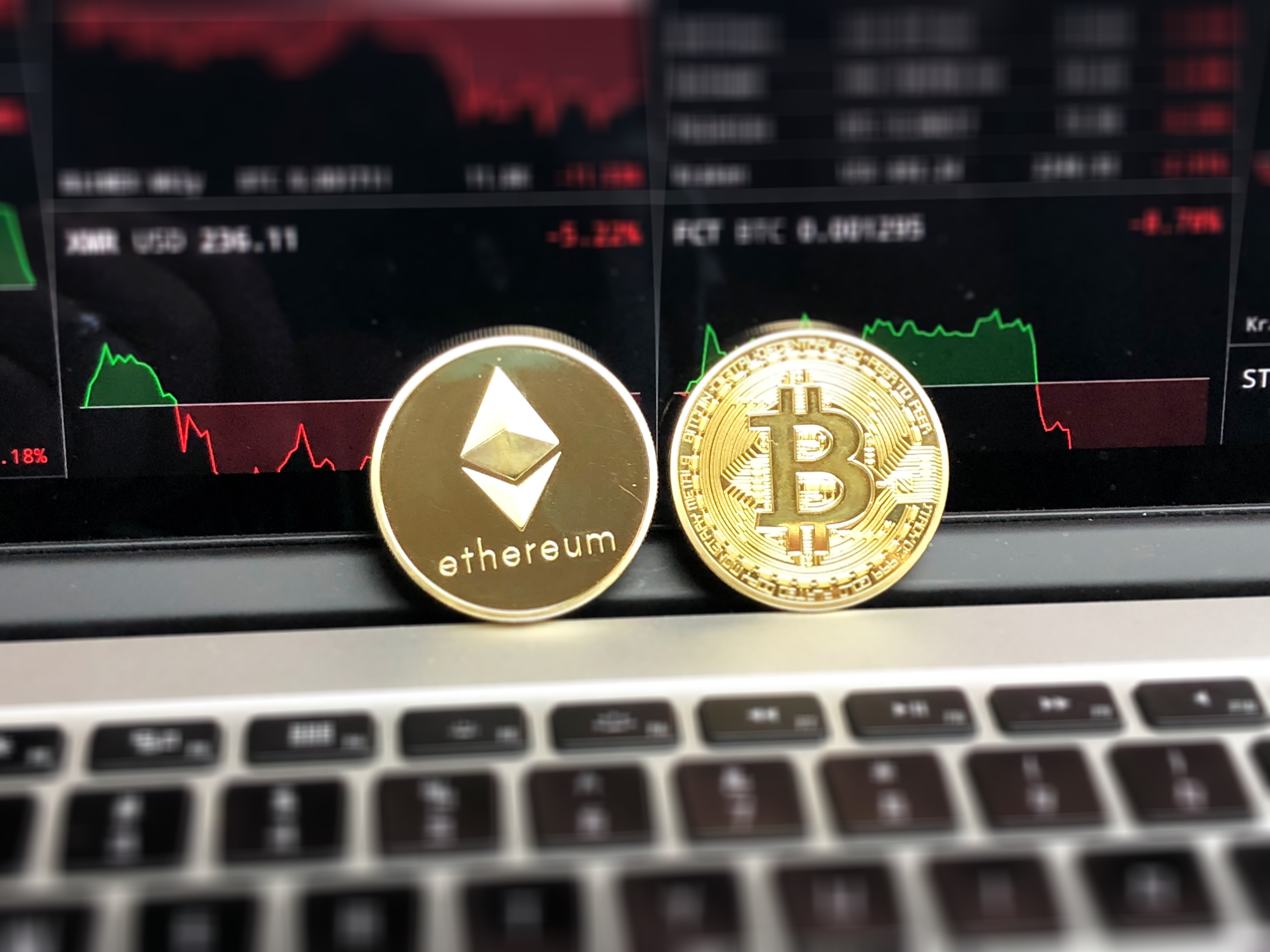 Ethereum and bitcoin emblems photo