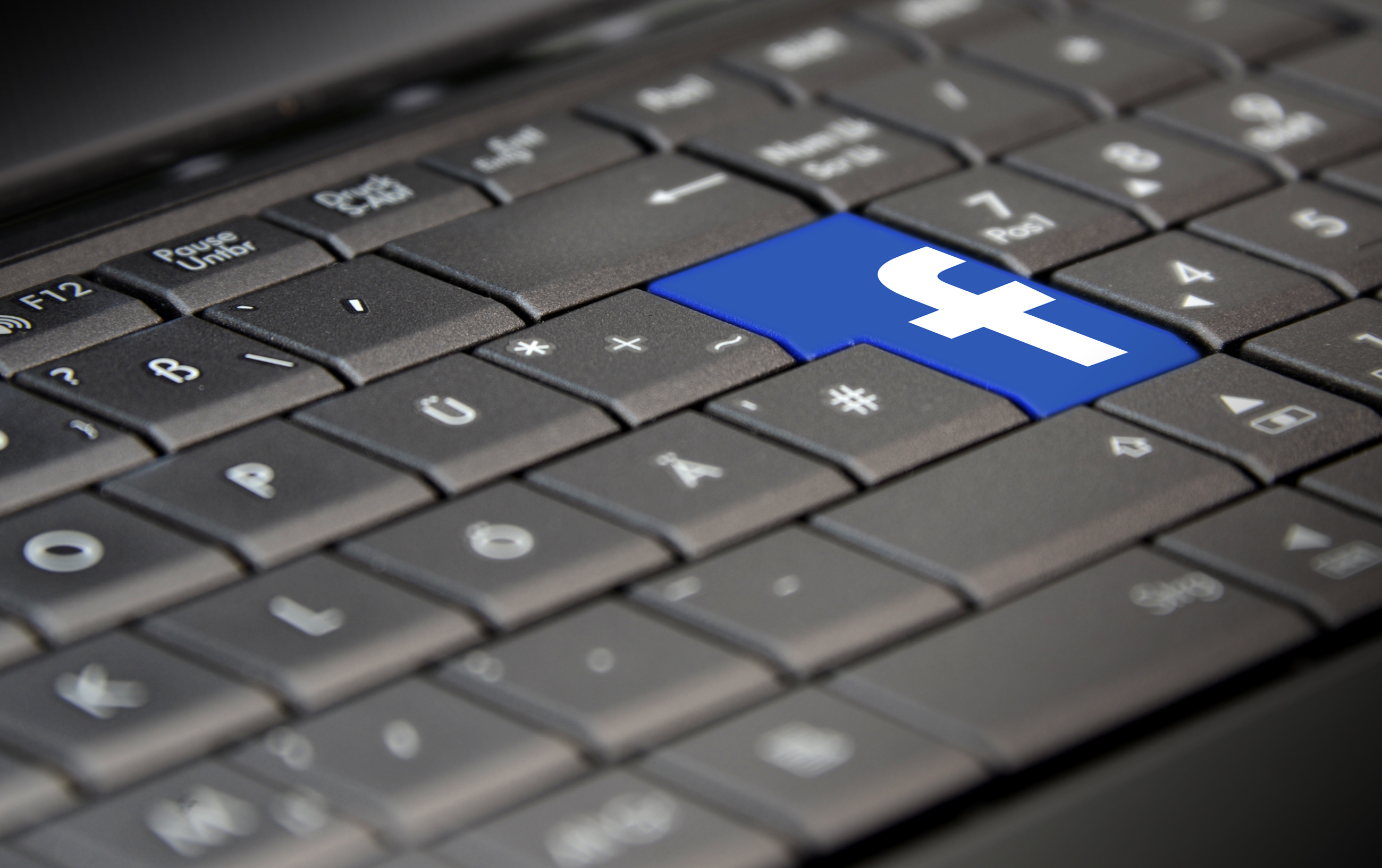 Facebook logo on laptop keyboard photo