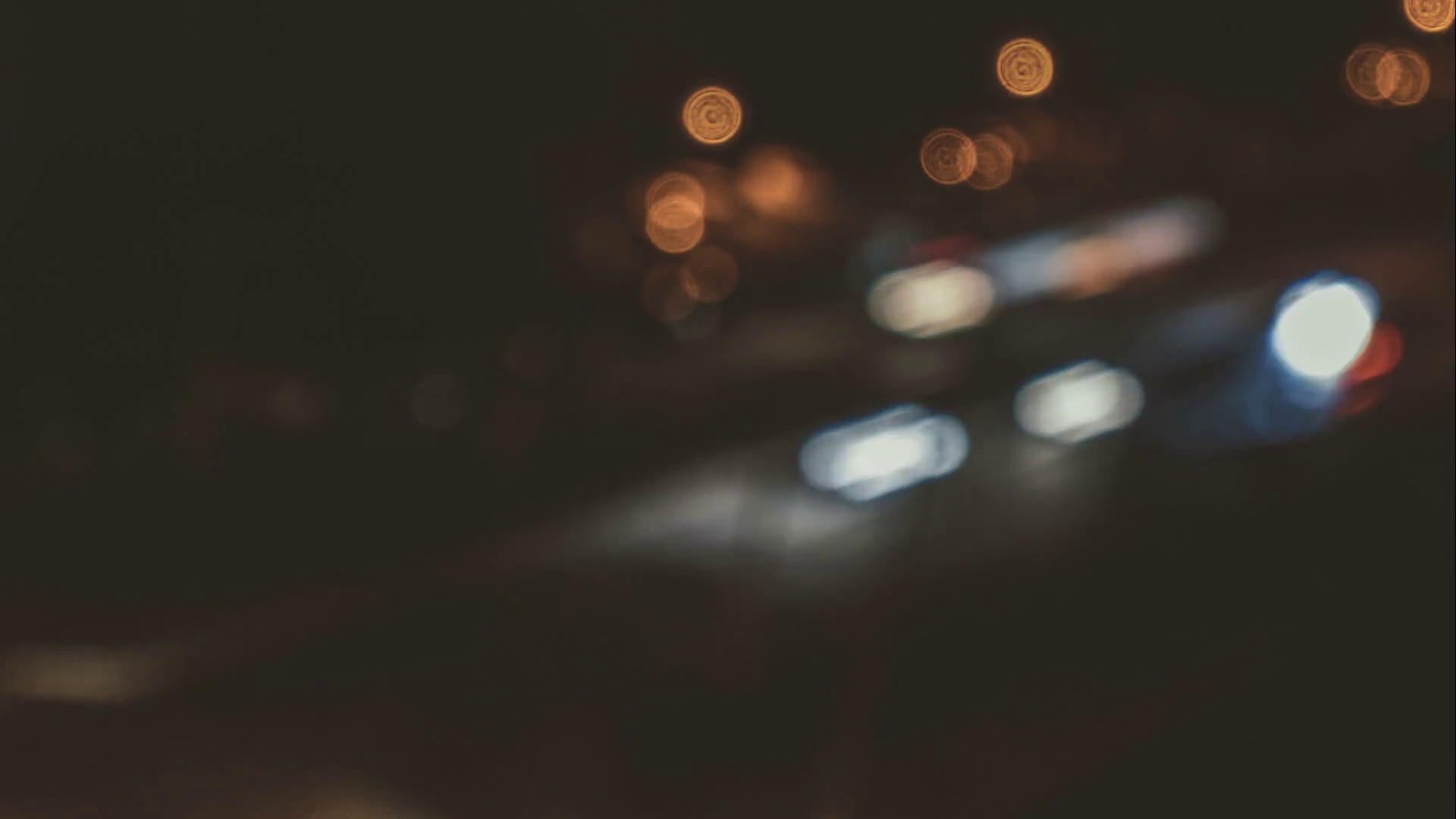 Bokeh blur late night dark street cars motion faded background time ...