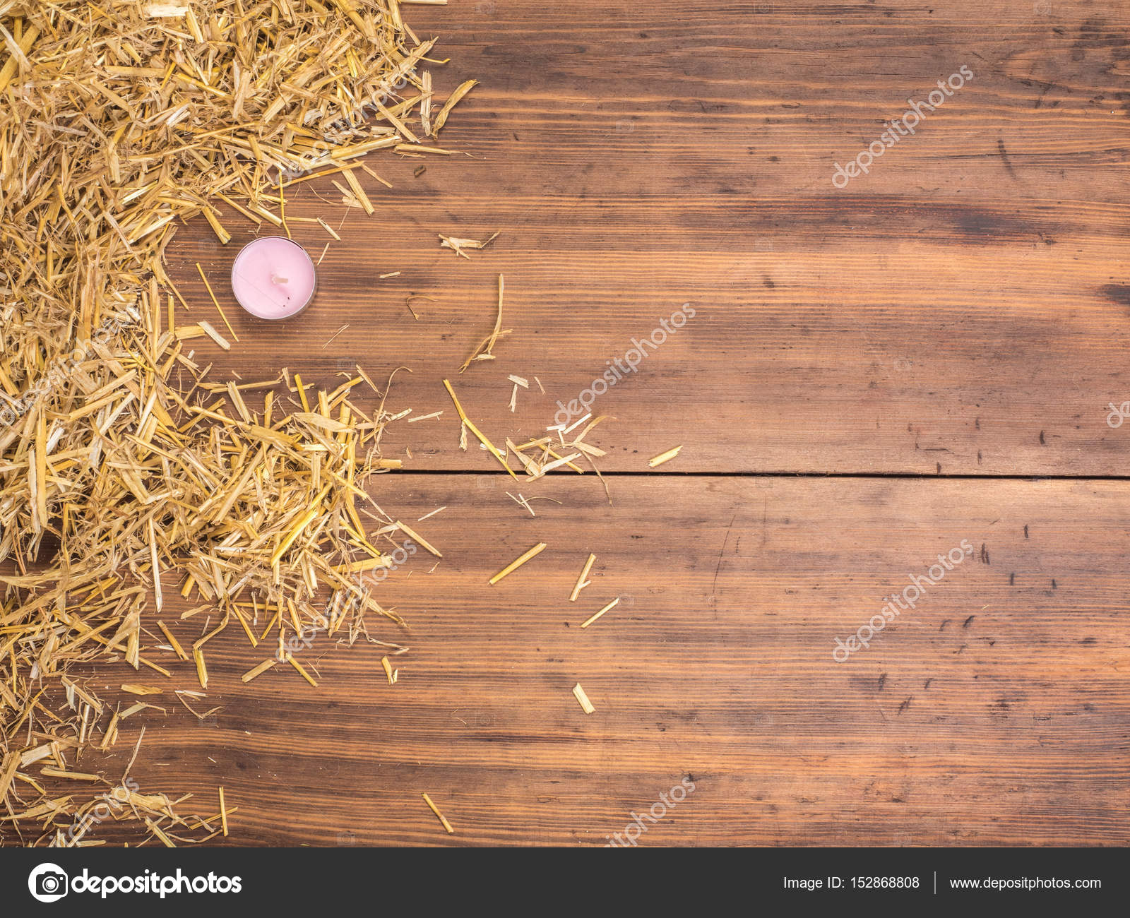 Rural eco background with colored candle and straw on the background ...