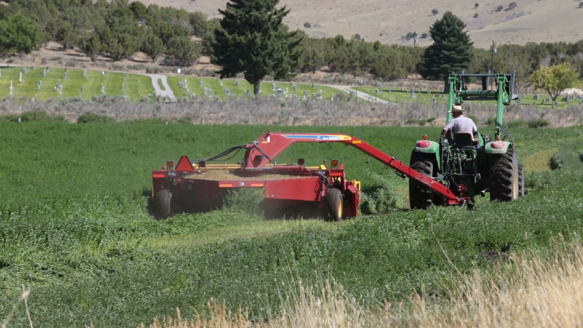 Farmer on tractor rural community cutting alfalfa hay P HD 2389 ...