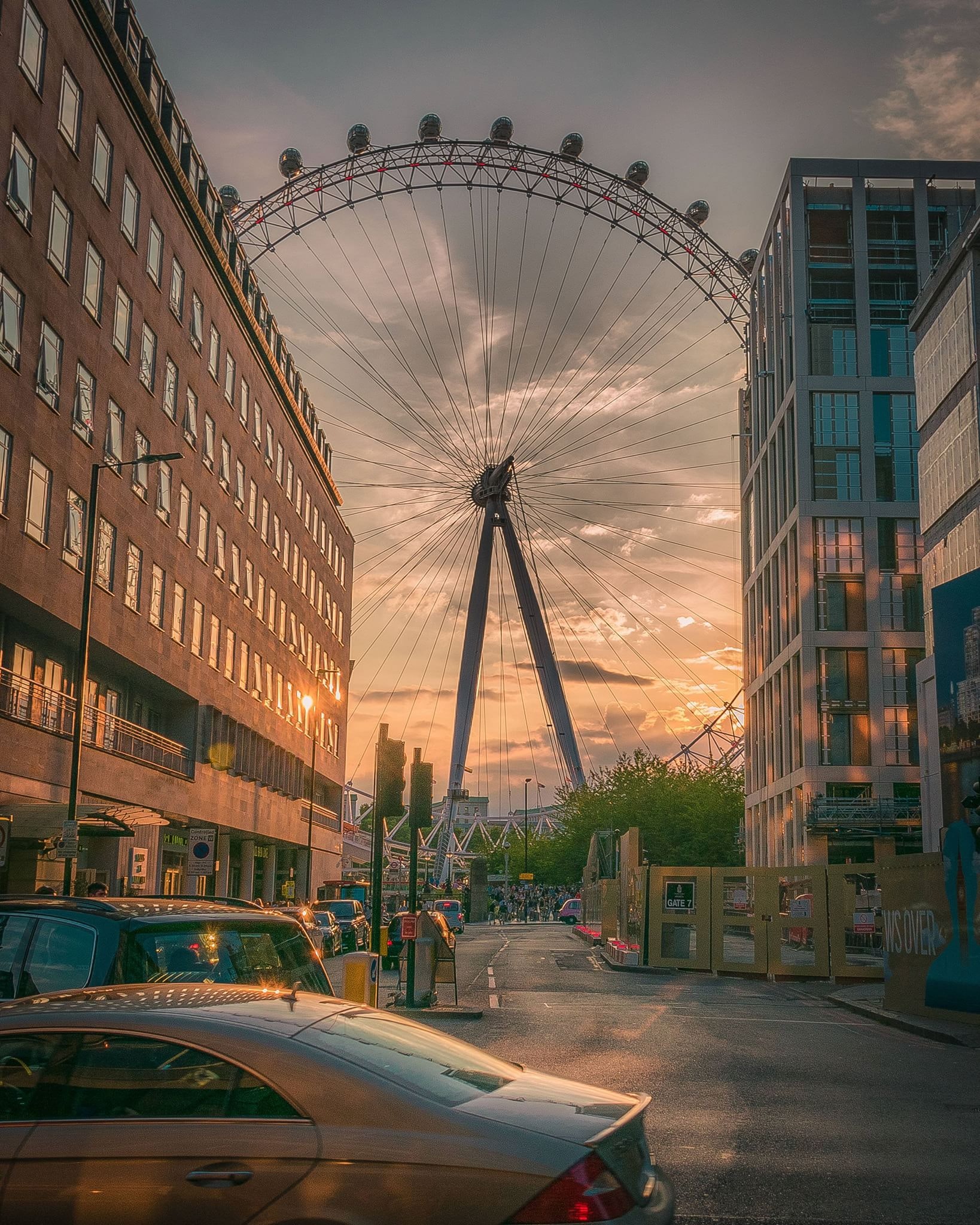 Ferris wheel near building during sunset photo