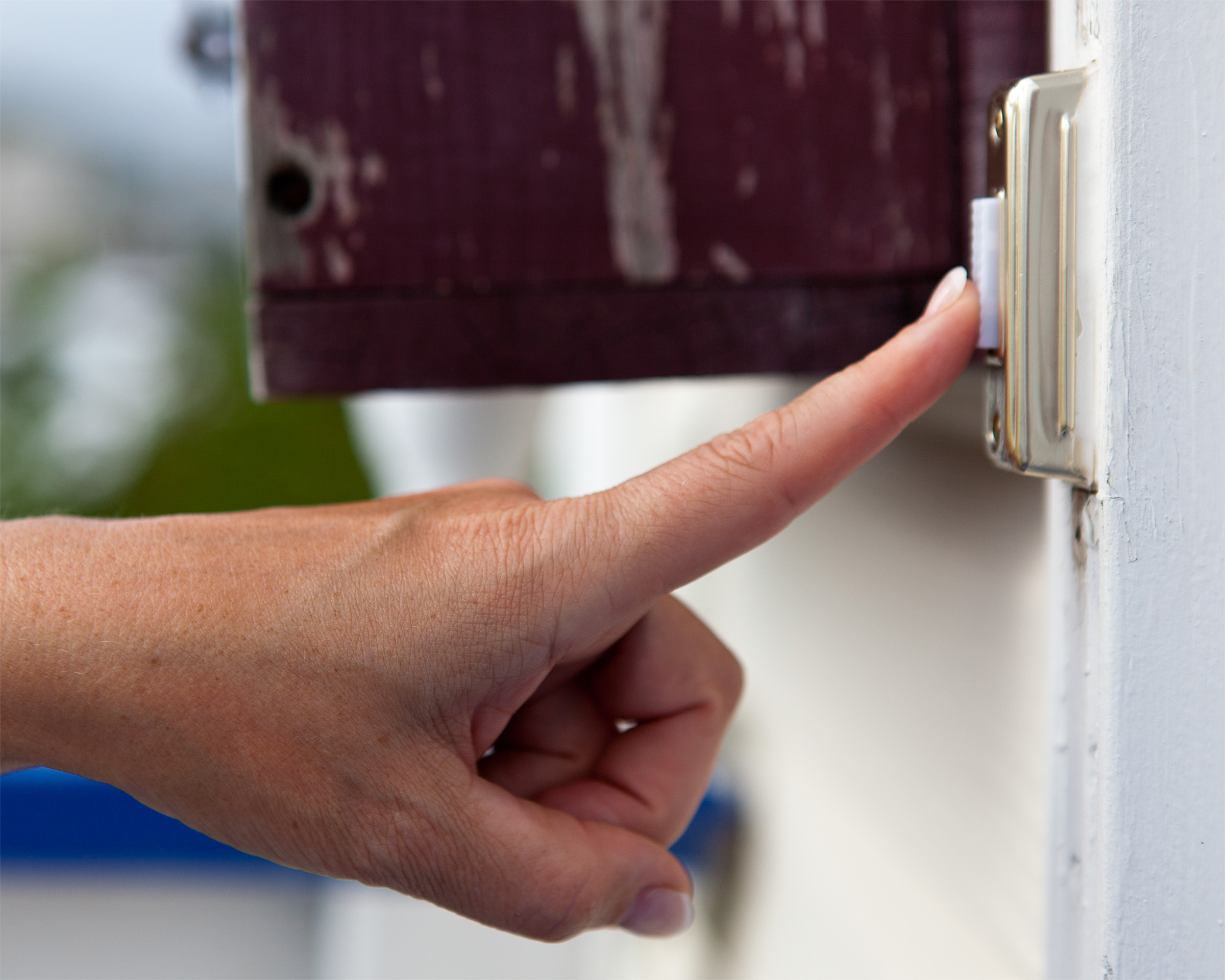 Finger pressing a doorbell photo