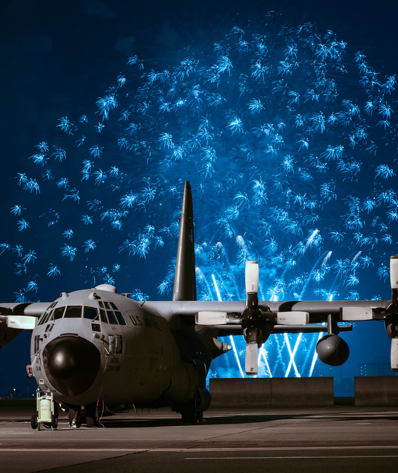 Electric Blue Fireworks Light Up the Sky Behind a C-130 Hercules ...