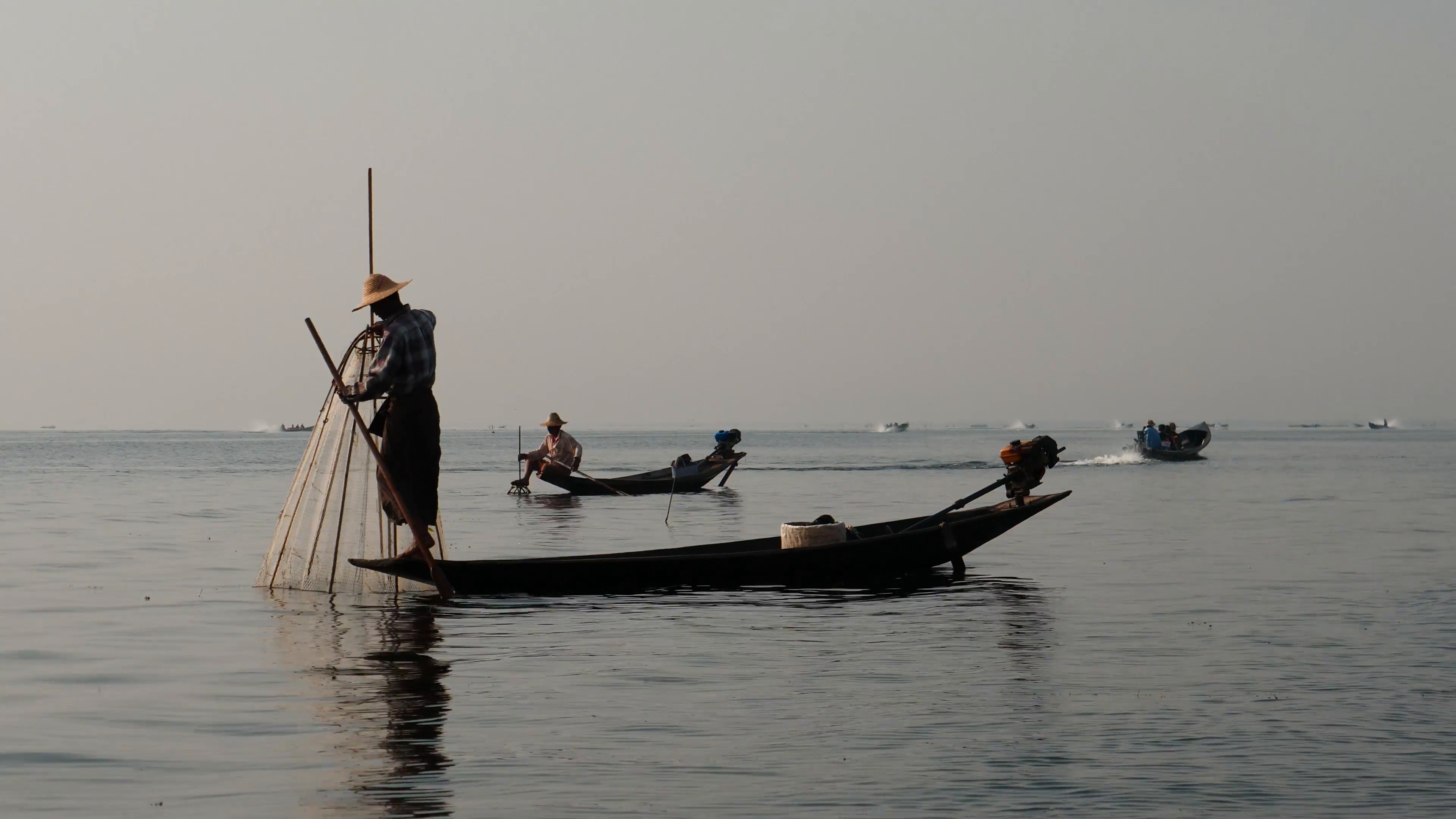 Fishers on boat in waters at Inle lake of Myanmar - view from ...