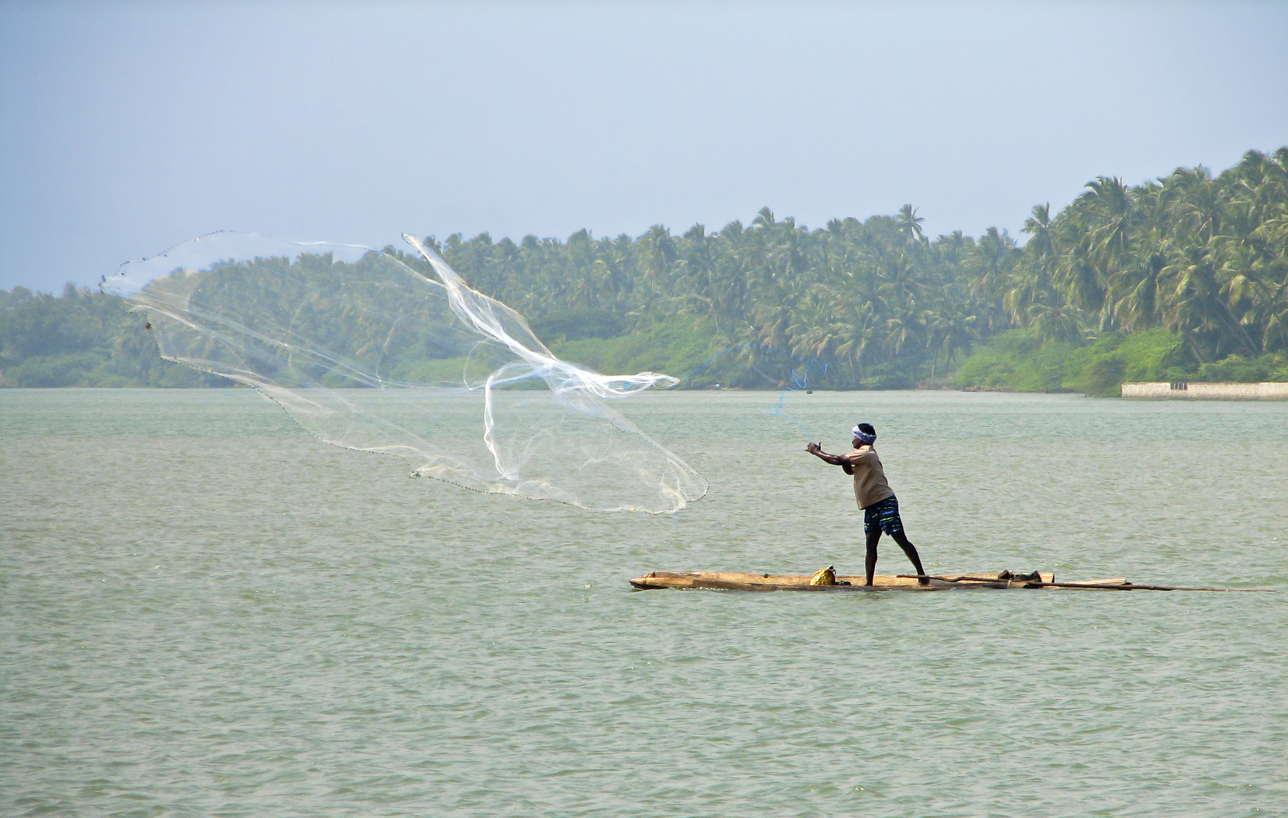 Fisherman cast net photo
