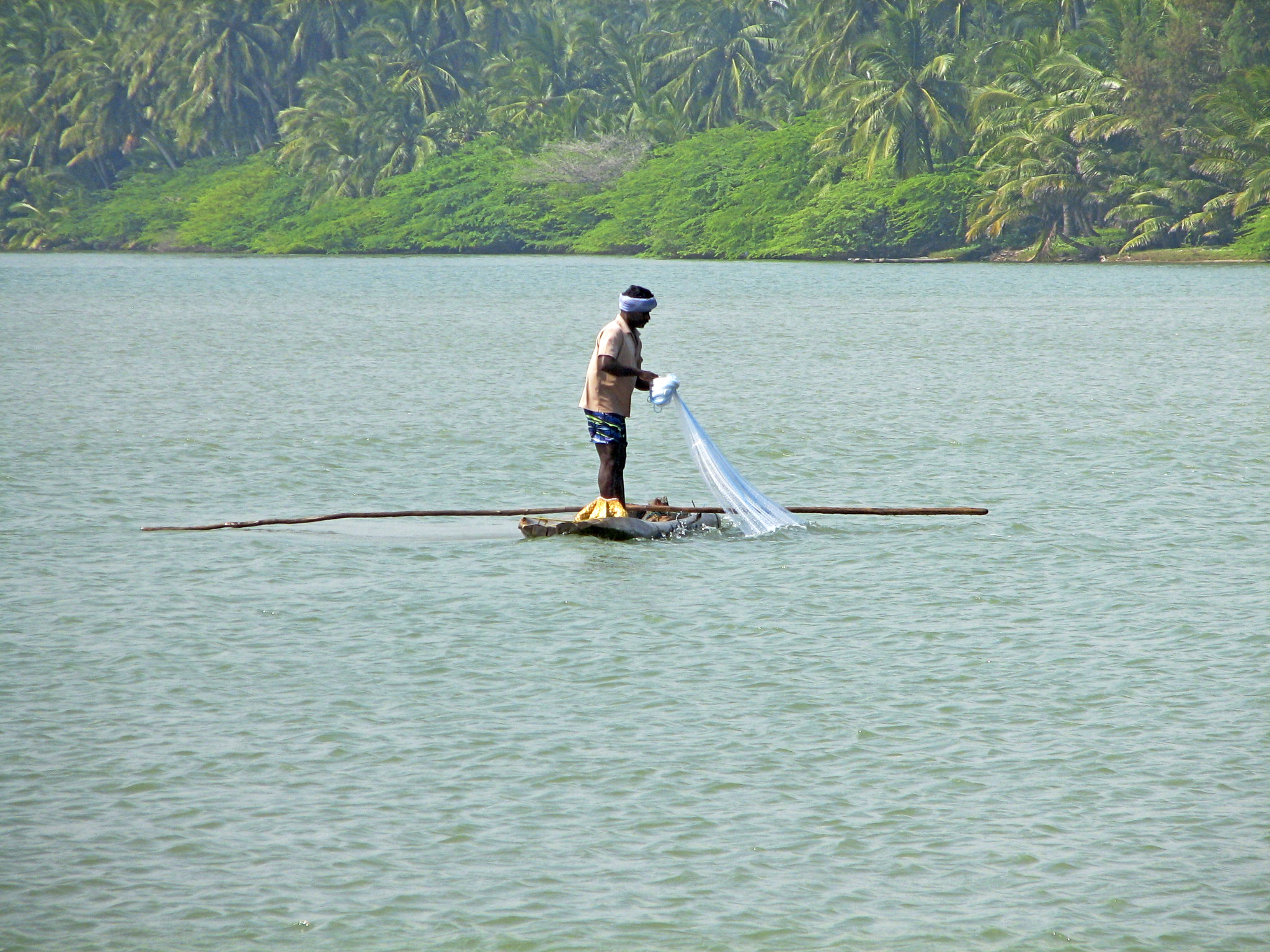 Fisherman in a log boat photo