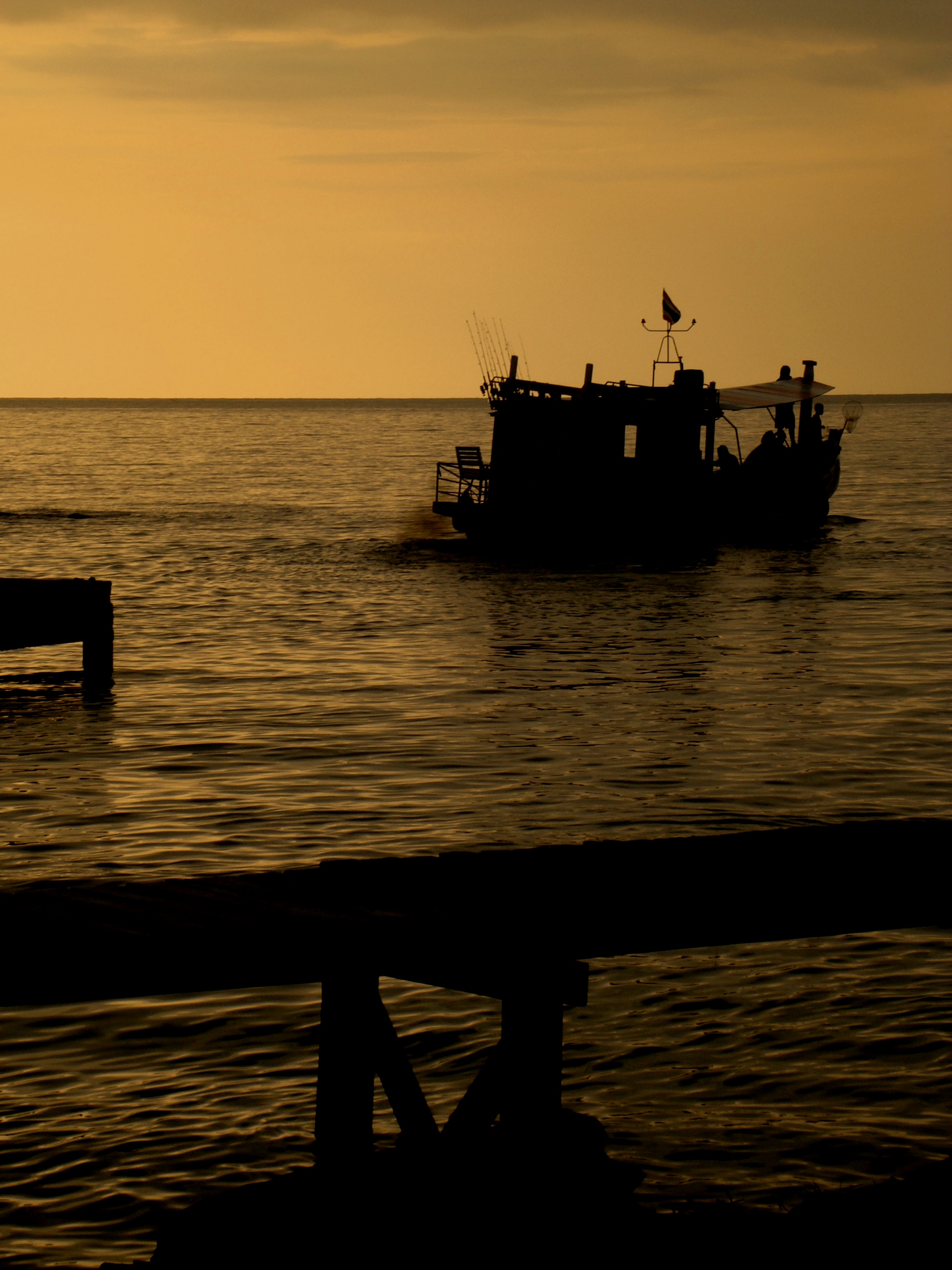 Fishing boat on golden sunset photo