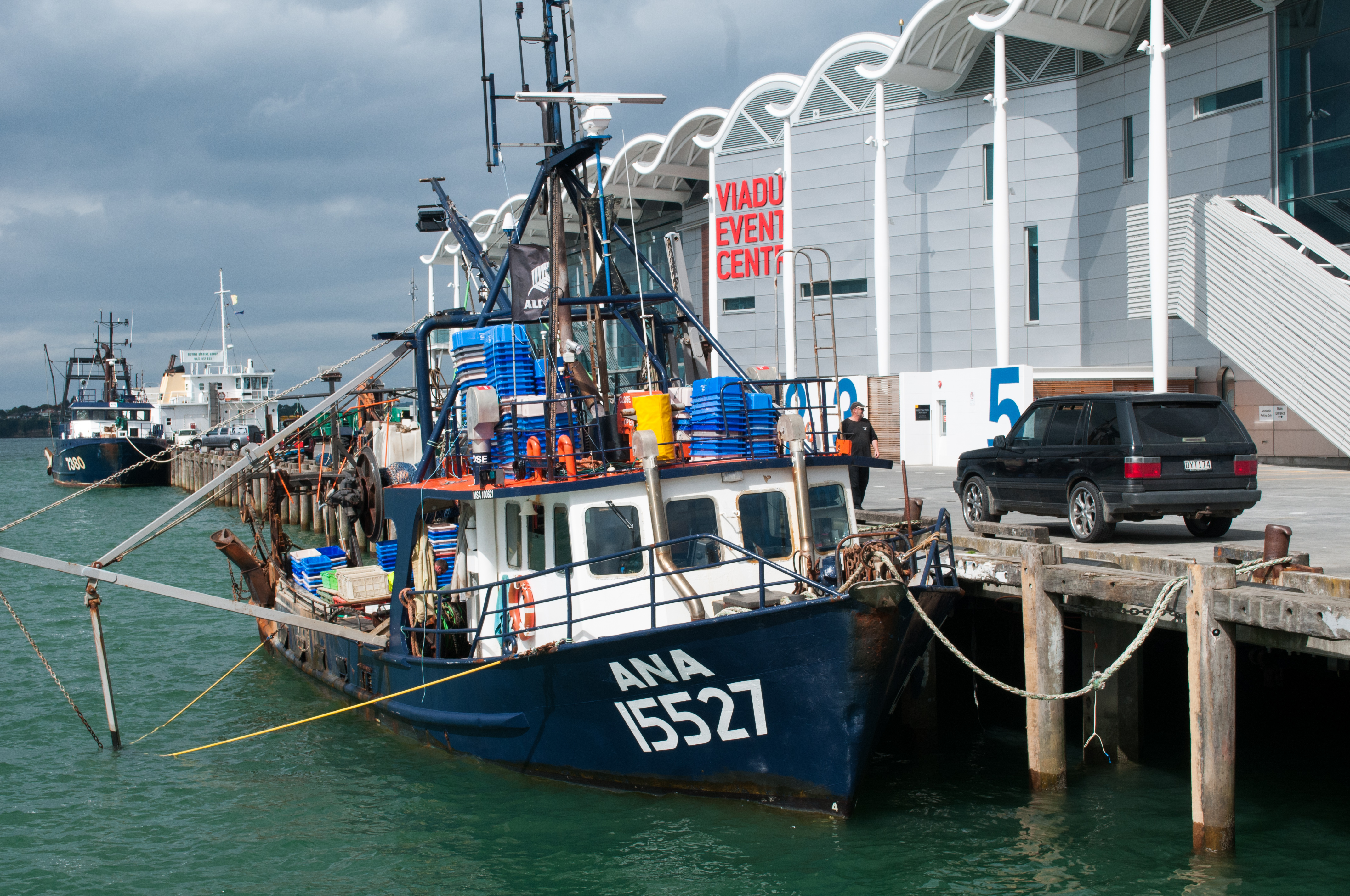 Fishing vessel docked in front of viaduct events centre photo
