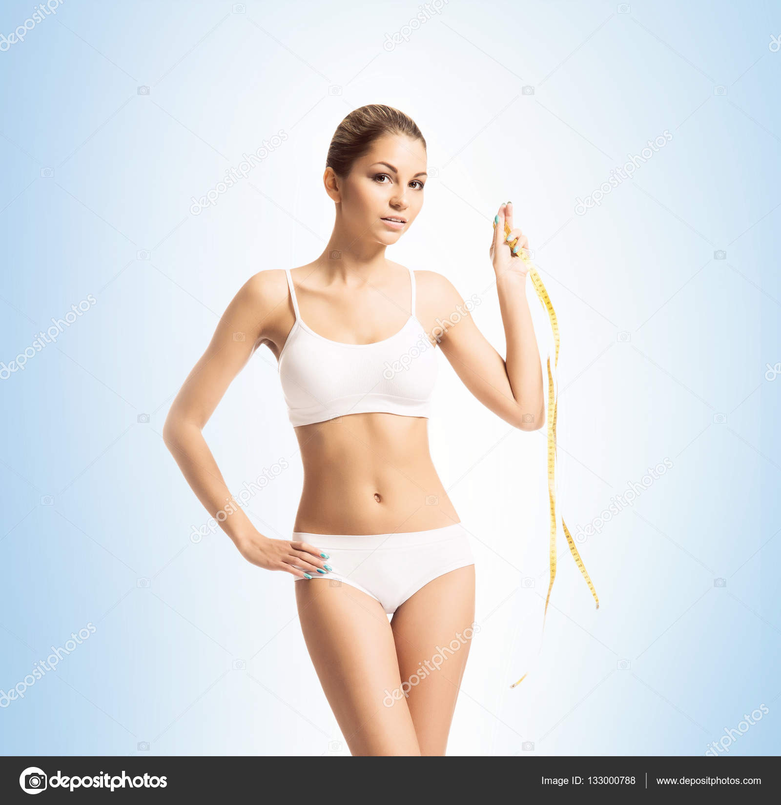 Young and fit woman in white sporty clothes — Stock Photo © shmeljov ...