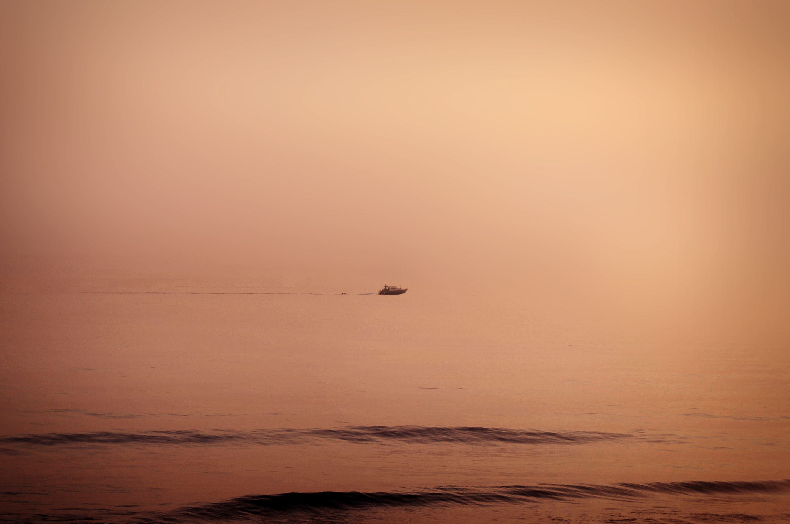 Floating - a lonely distant boat cruisin photo