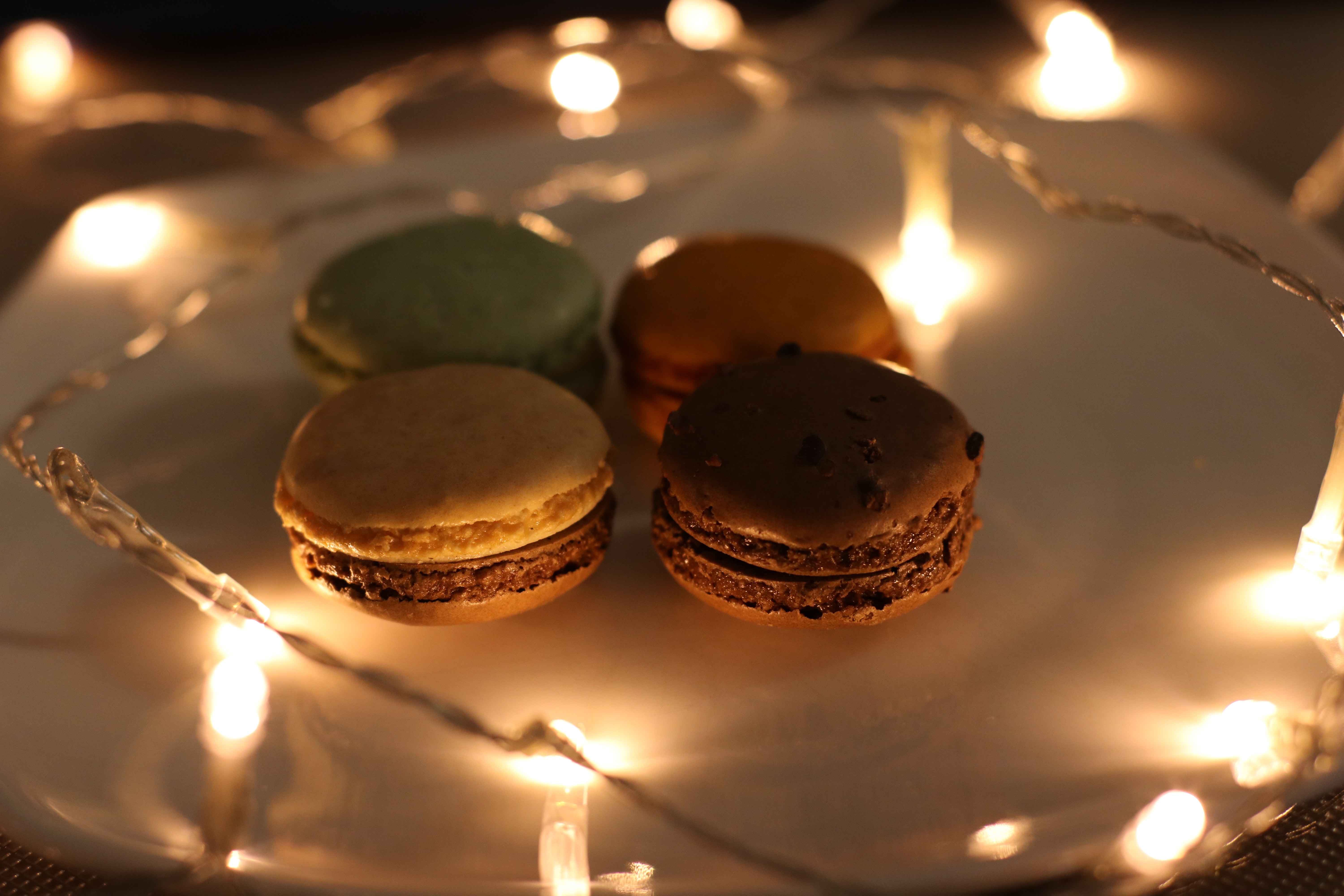 Four assorted macaroons on plate photo
