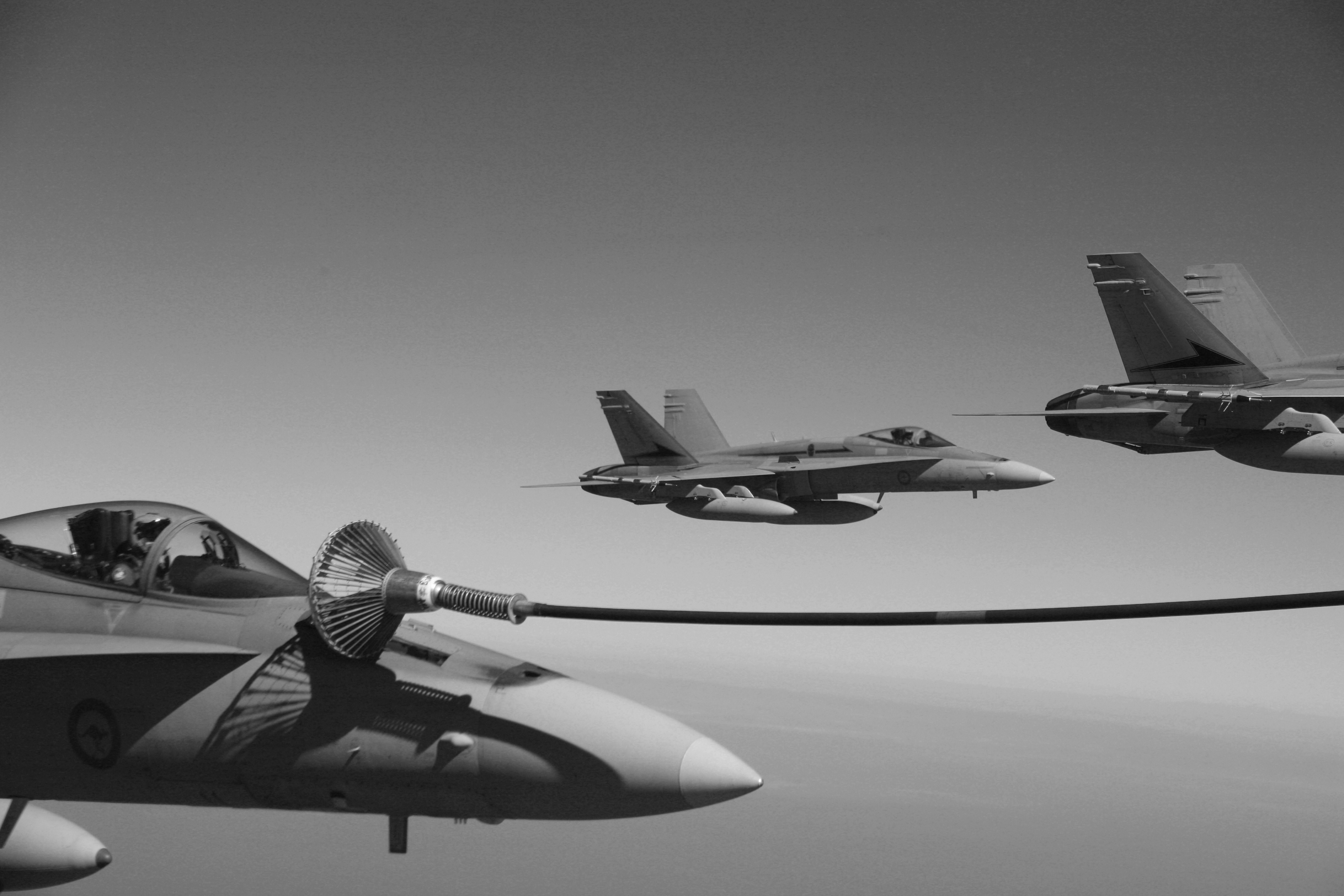 Four australian fa-18 aircrafts from the royal australian air force 77 squadron refueled alongside u.s. fa-18 hornet aircraft from marine fighter attack squadron 212 off the coast of australia june 20, 2007, during the exercise talisman sabre photo