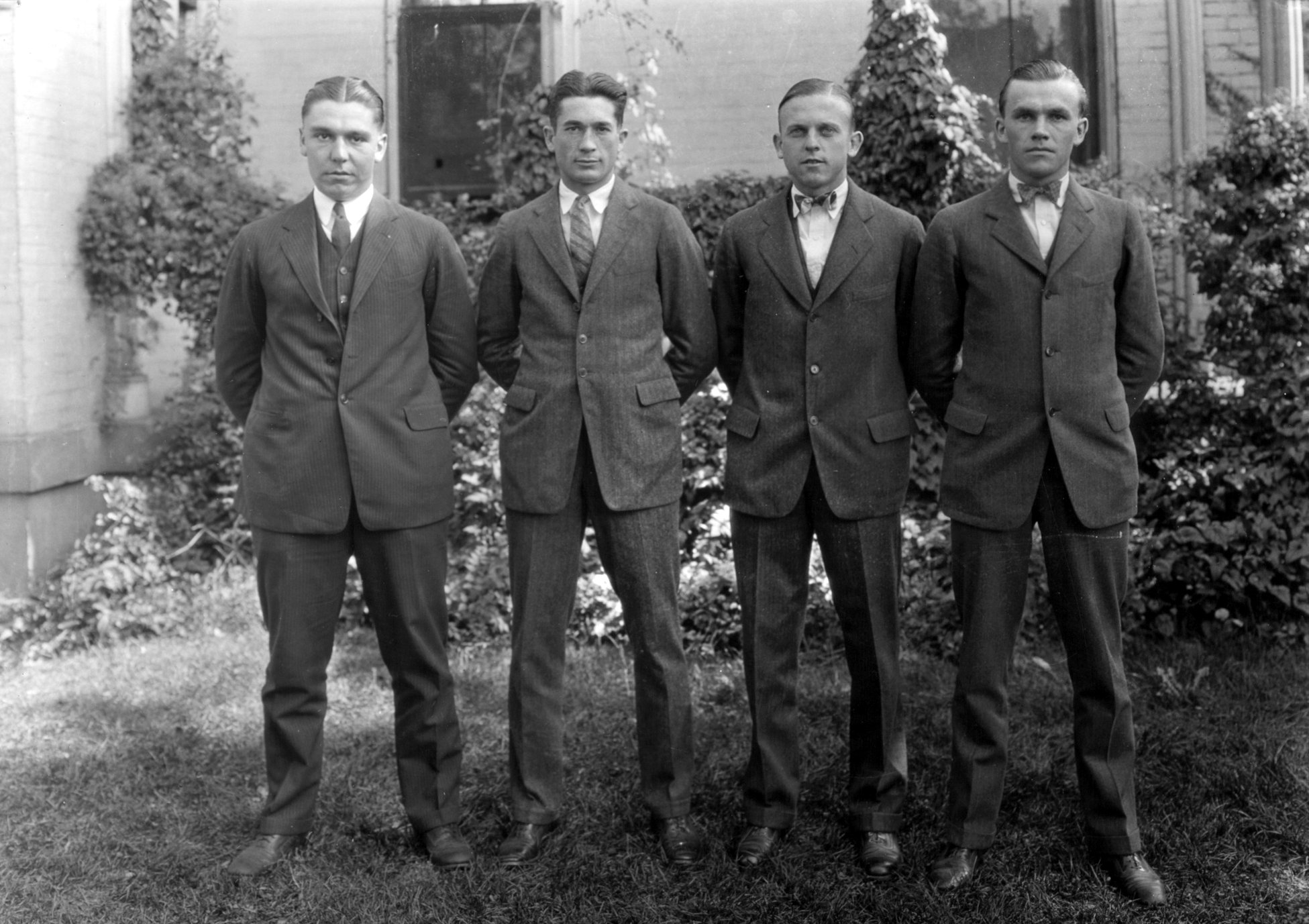 Four unidentified men in suits - ExploreUK