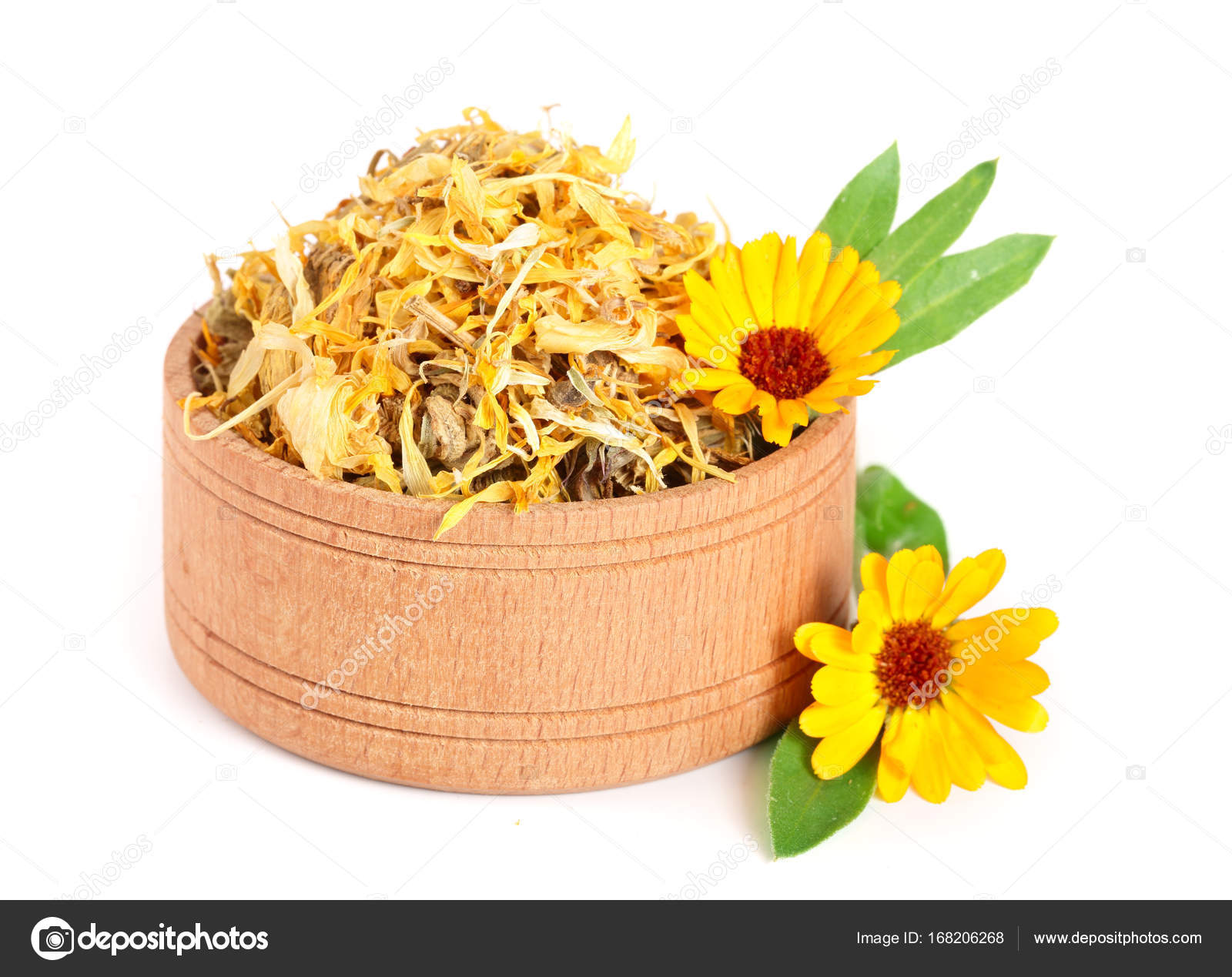 Fresh and dried calendula flowers in a wooden bowl isolated on white ...