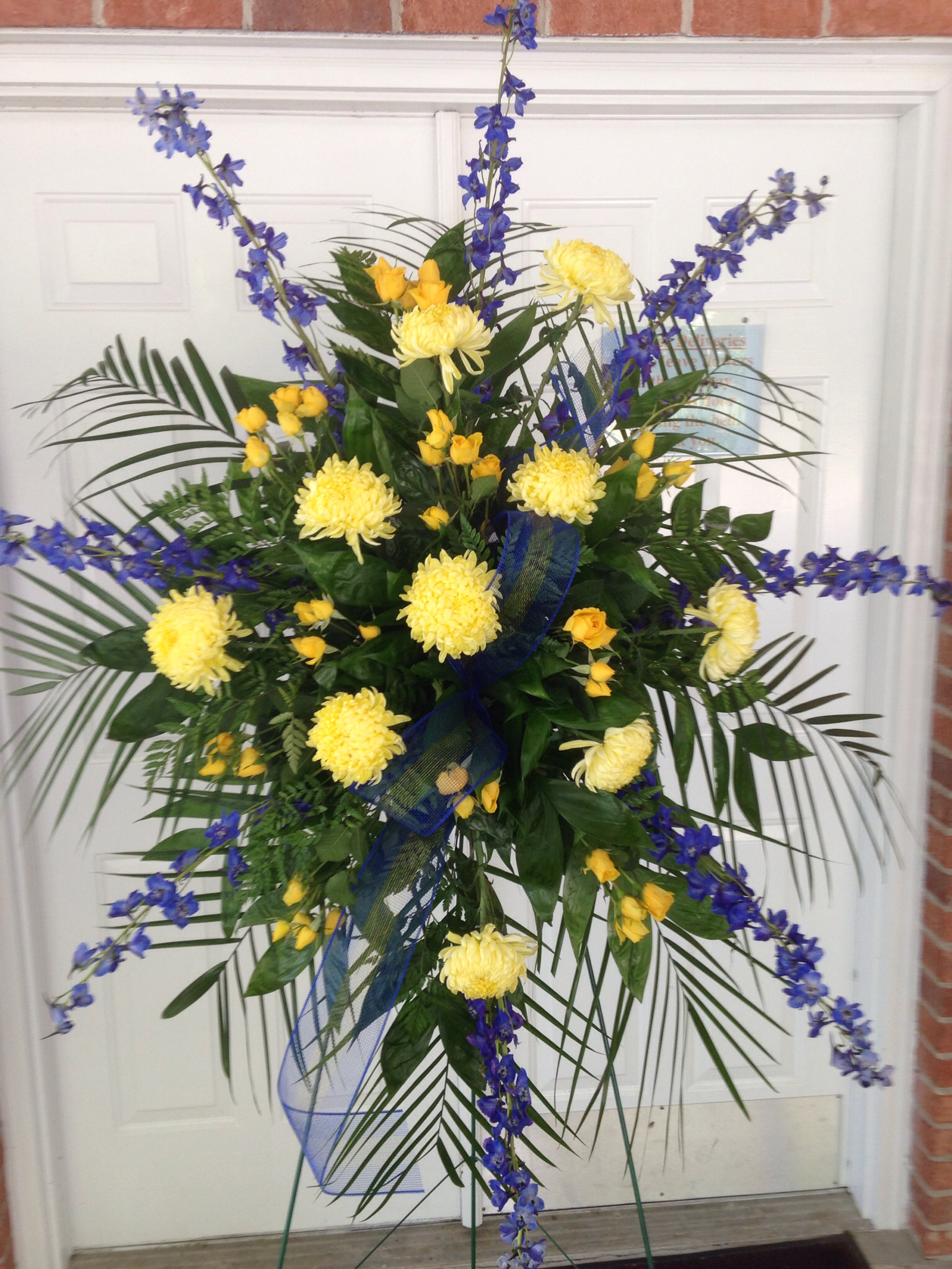 Fresh spray with blue delphinium, yellow mums and yellow roses ...
