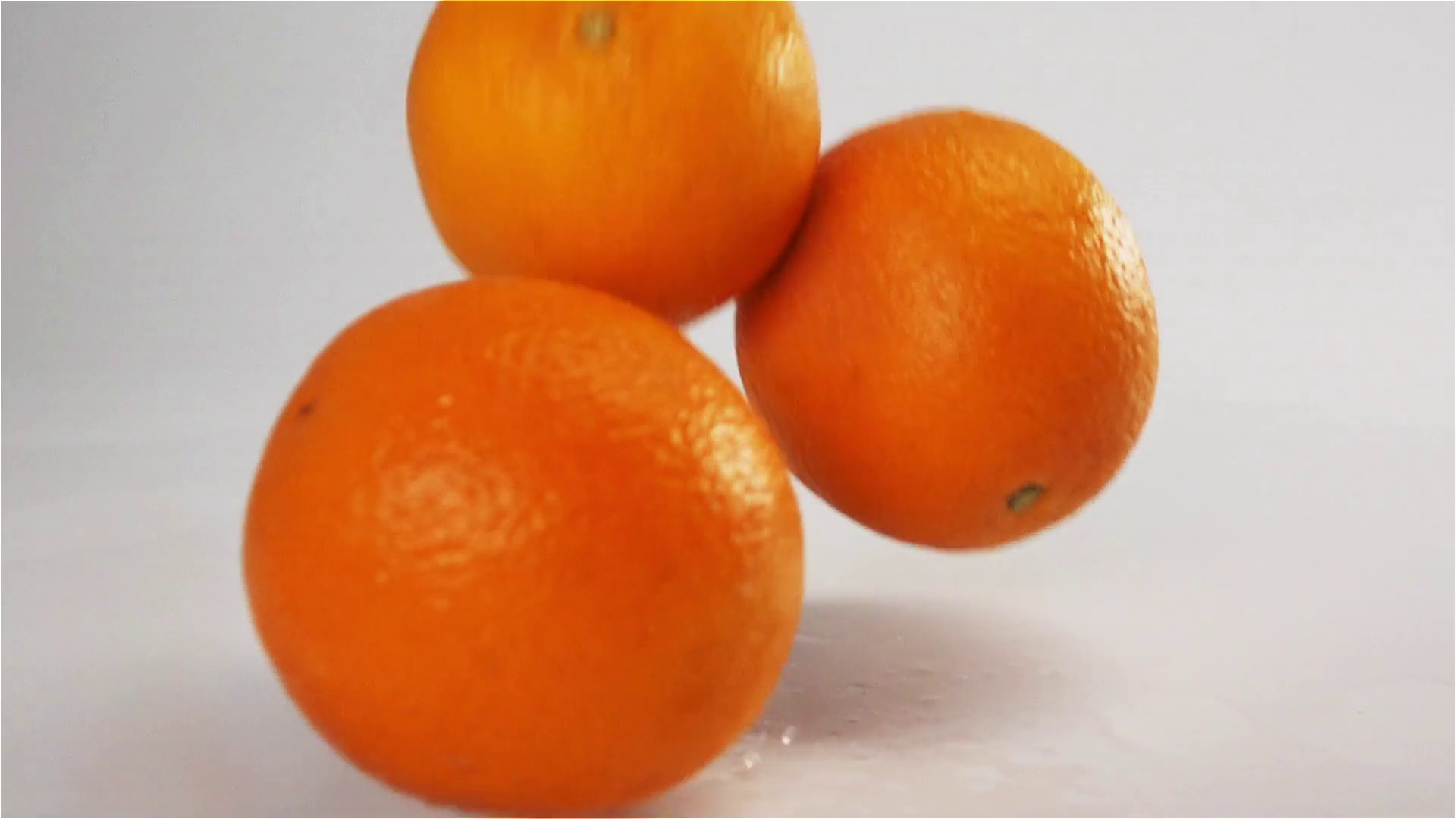 Fresh tasty Oranges fall and bounce on white wet surface with splash ...