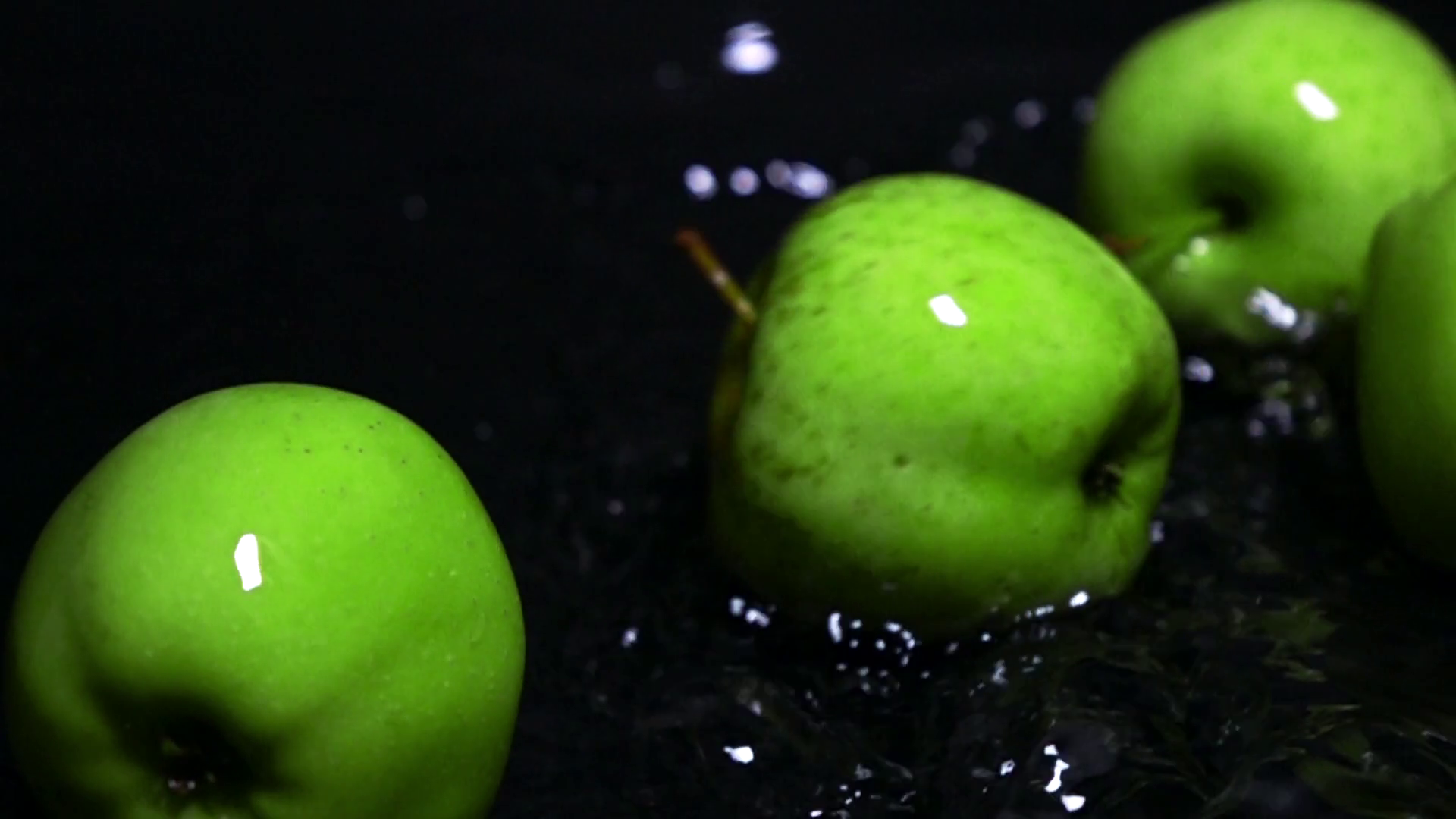 Rolling wet green apples and water ripple super slow motion video ...