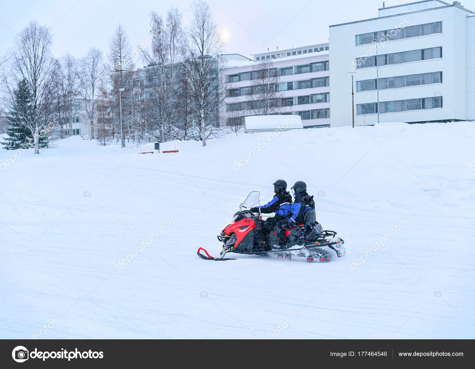 People ride snowmobile on frozen snow lake in winter Rovaniemi ...