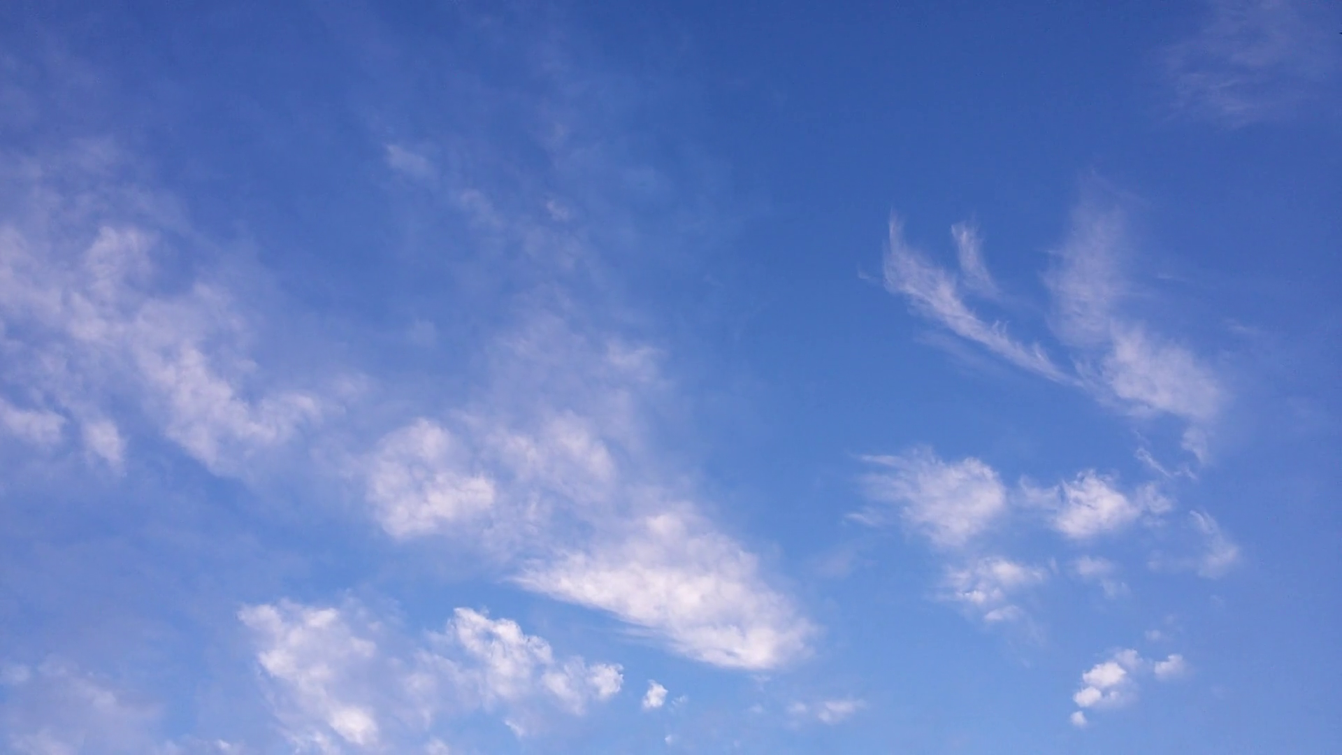 Timelapse - White gentle clouds passing in the blue sky on a sunny ...