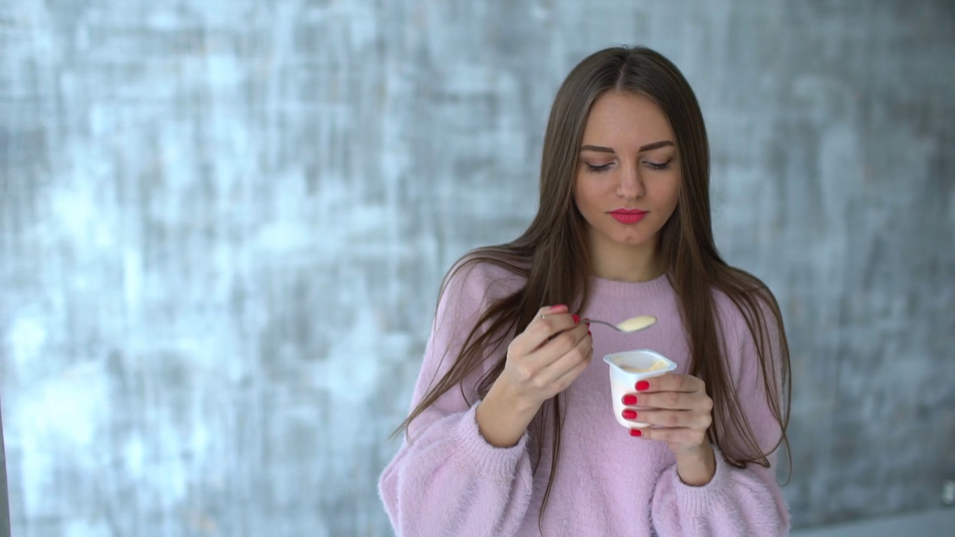 woman eating yogurt. slow-motion. pretty young woman eats a yogurt ...