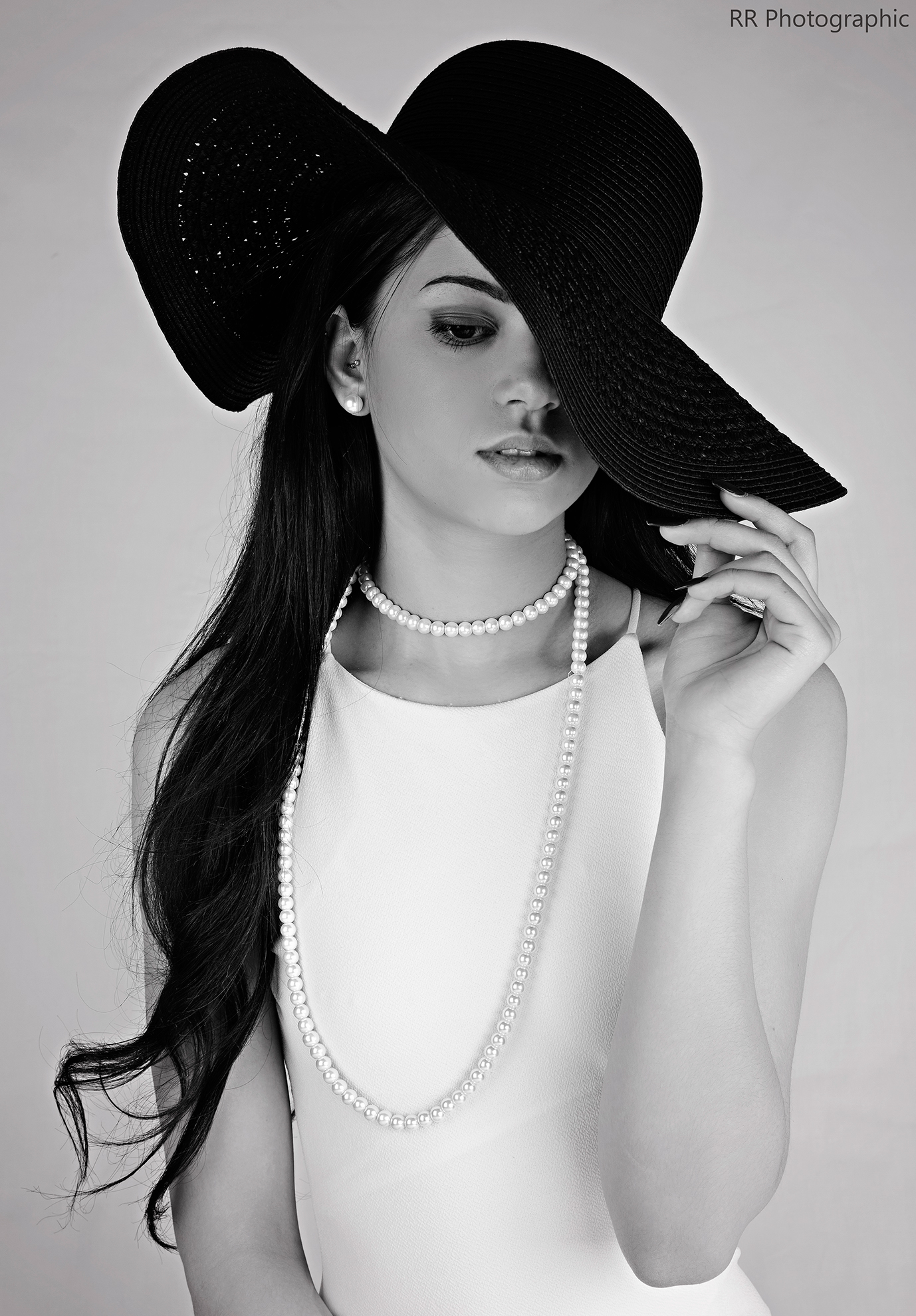 Commercial fashion photo of girl in a black hat black and white