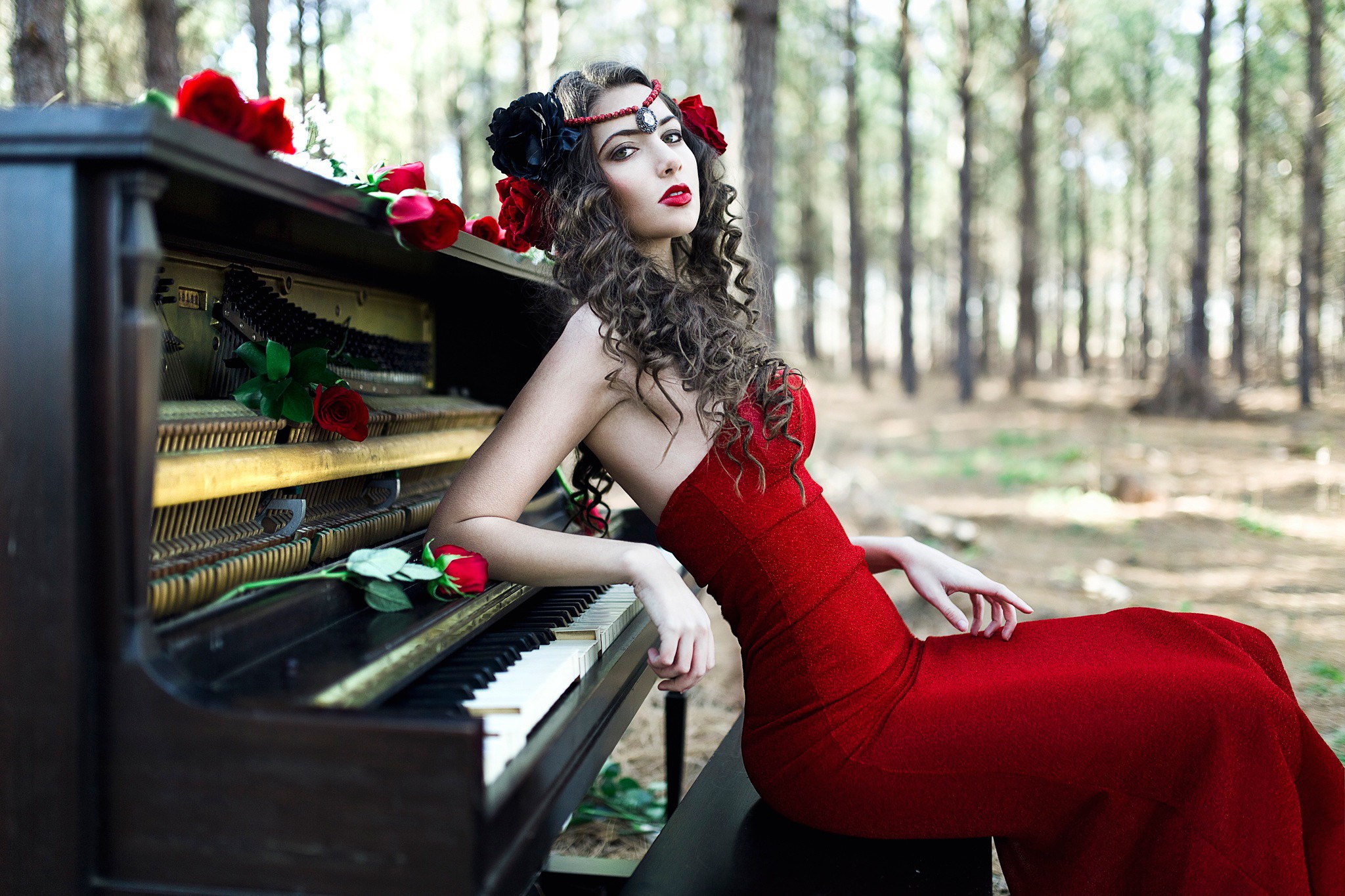 The girl in the red dress sitting at the piano