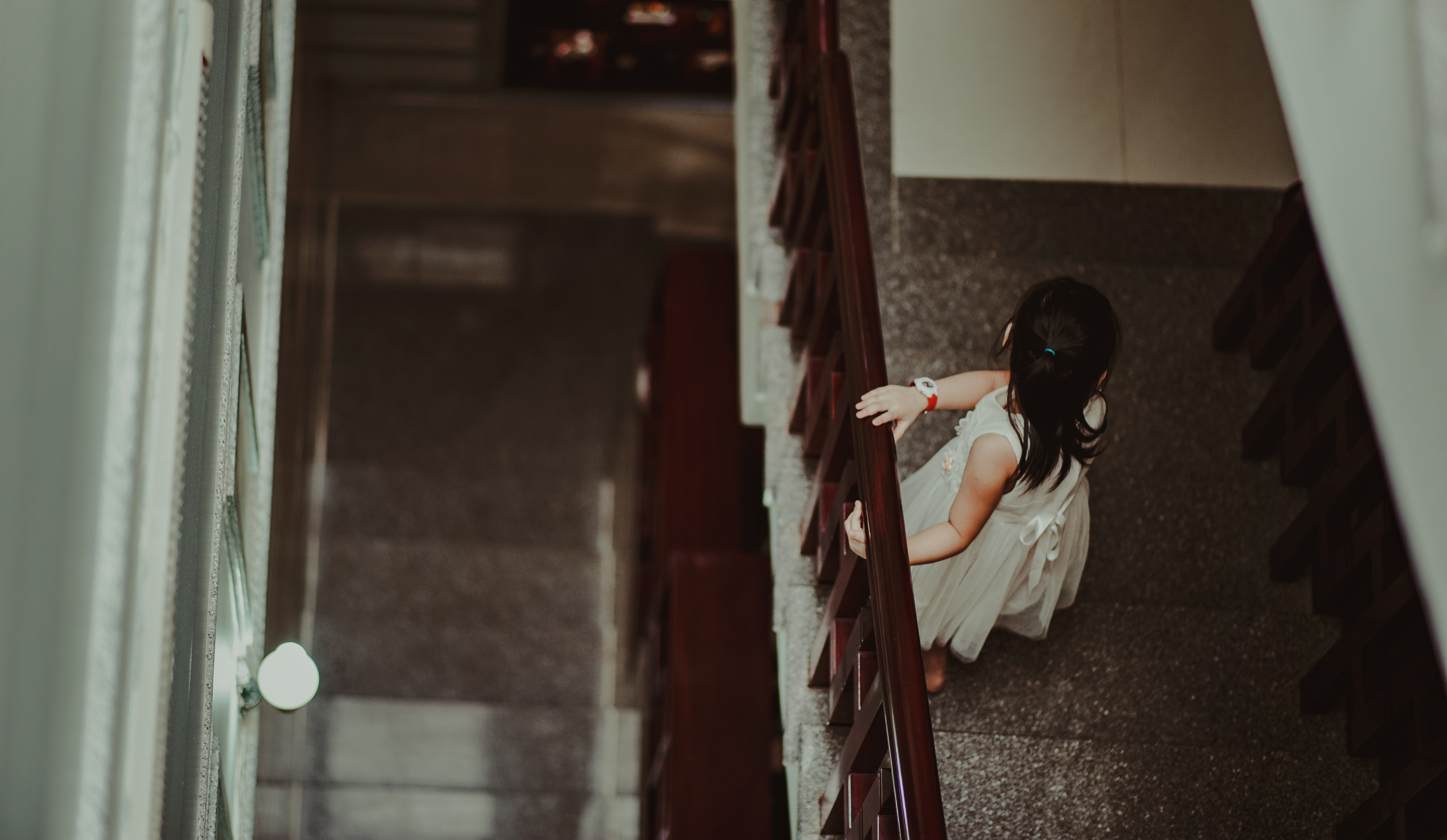 Girl in white dress standing in front of railings photo