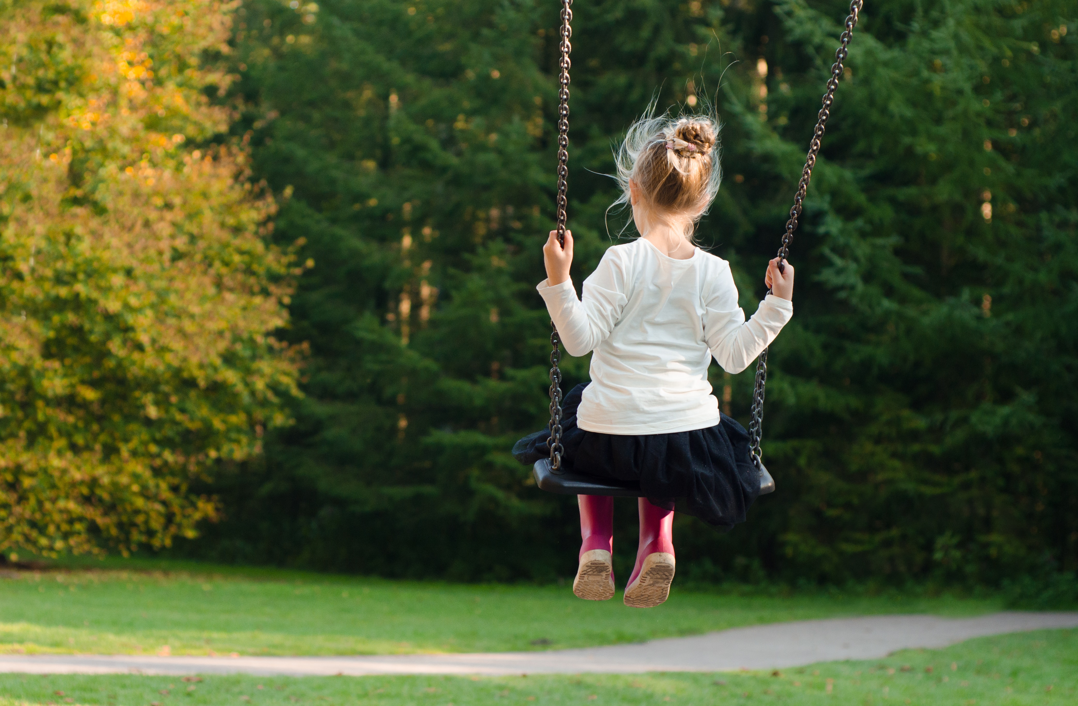 Girl in White Long Sleeve Shirt and Black Skirt Sitting on Swing during Day Time, Child, Girl, Kid, Person, HQ Photo