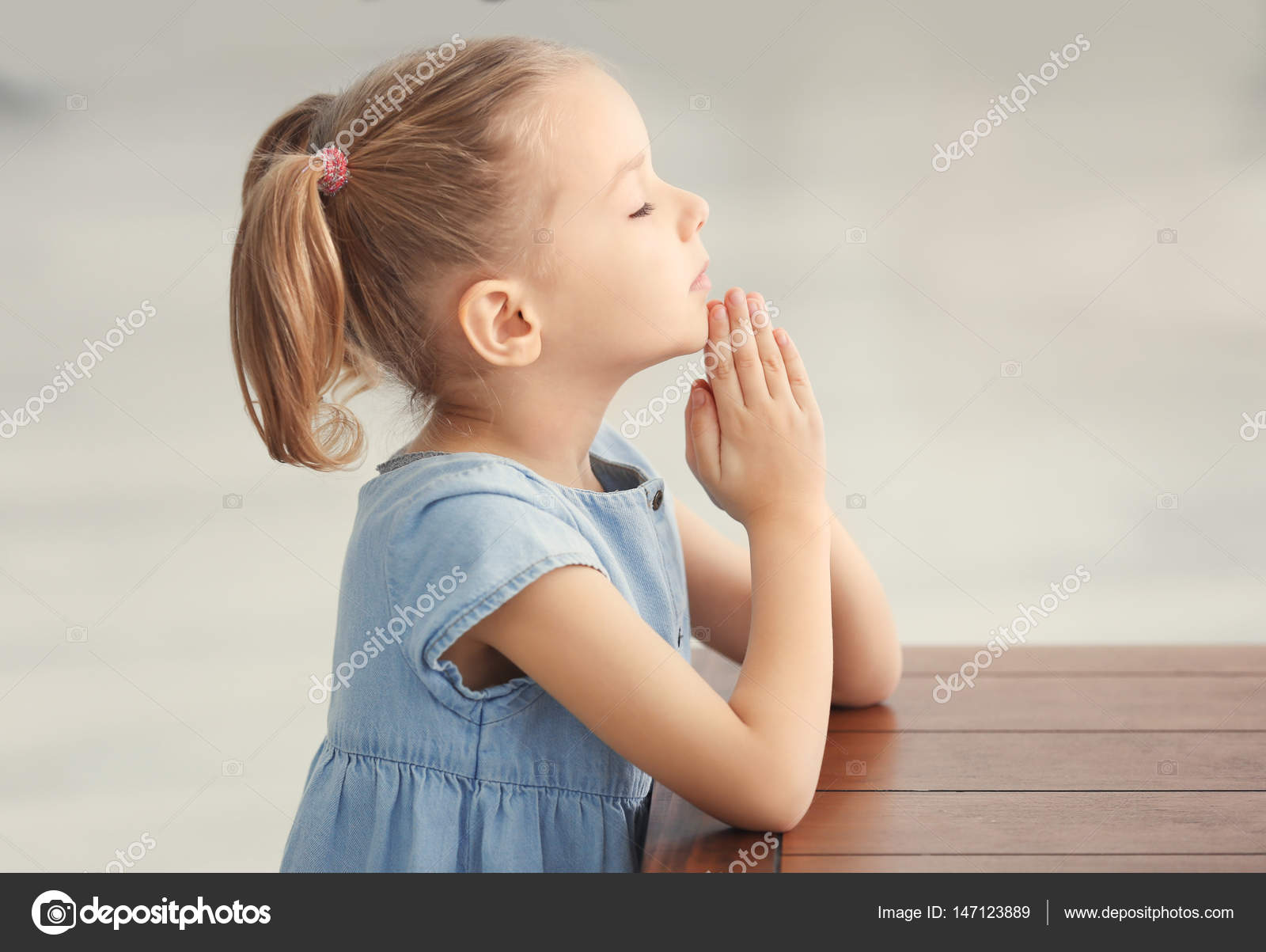 little girl praying — Stock Photo © belchonock #147123889