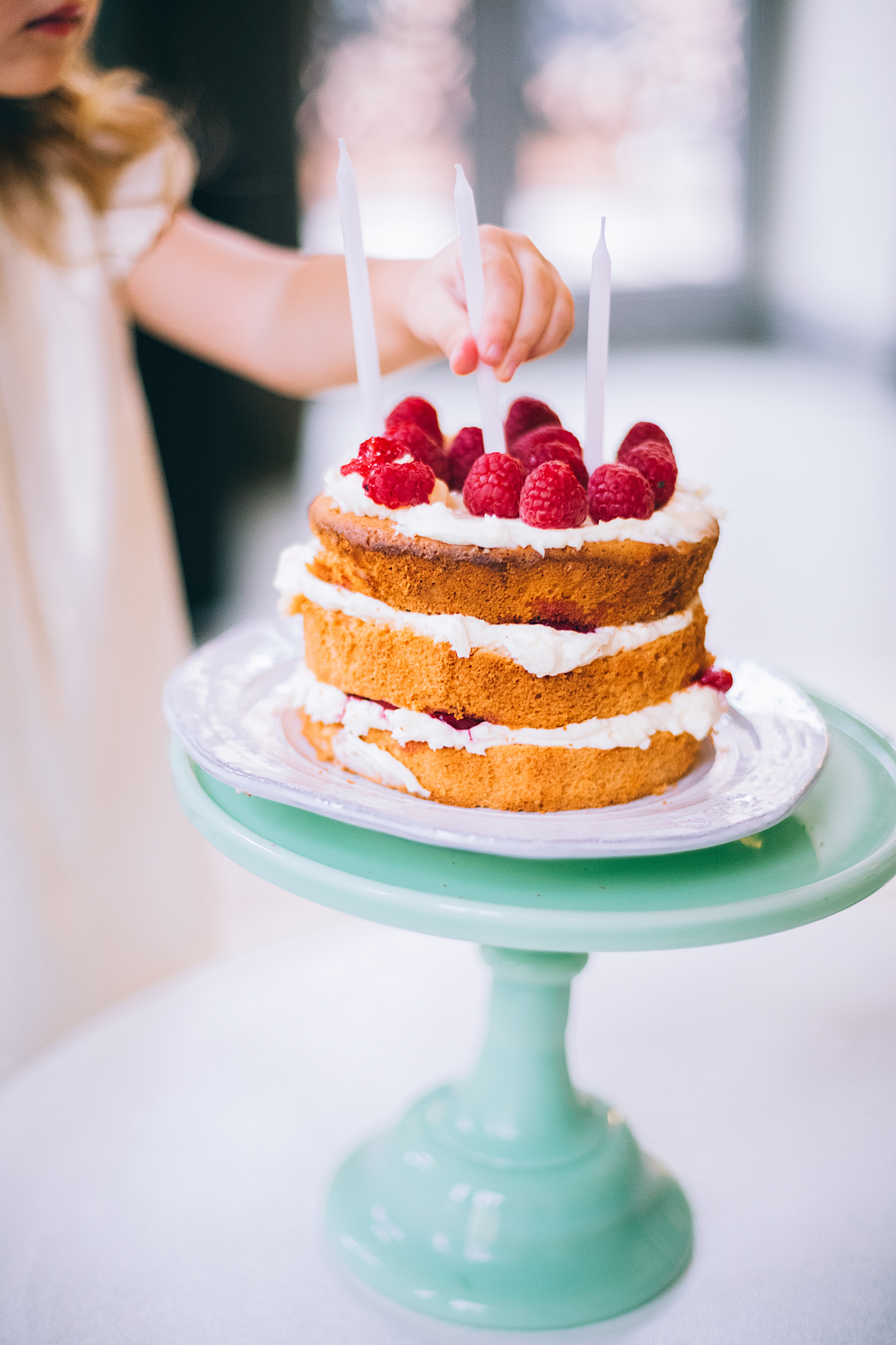 Girl Putting a Candle on 3-layered Cake, Baked, Food, Plate, Pastry, HQ Photo