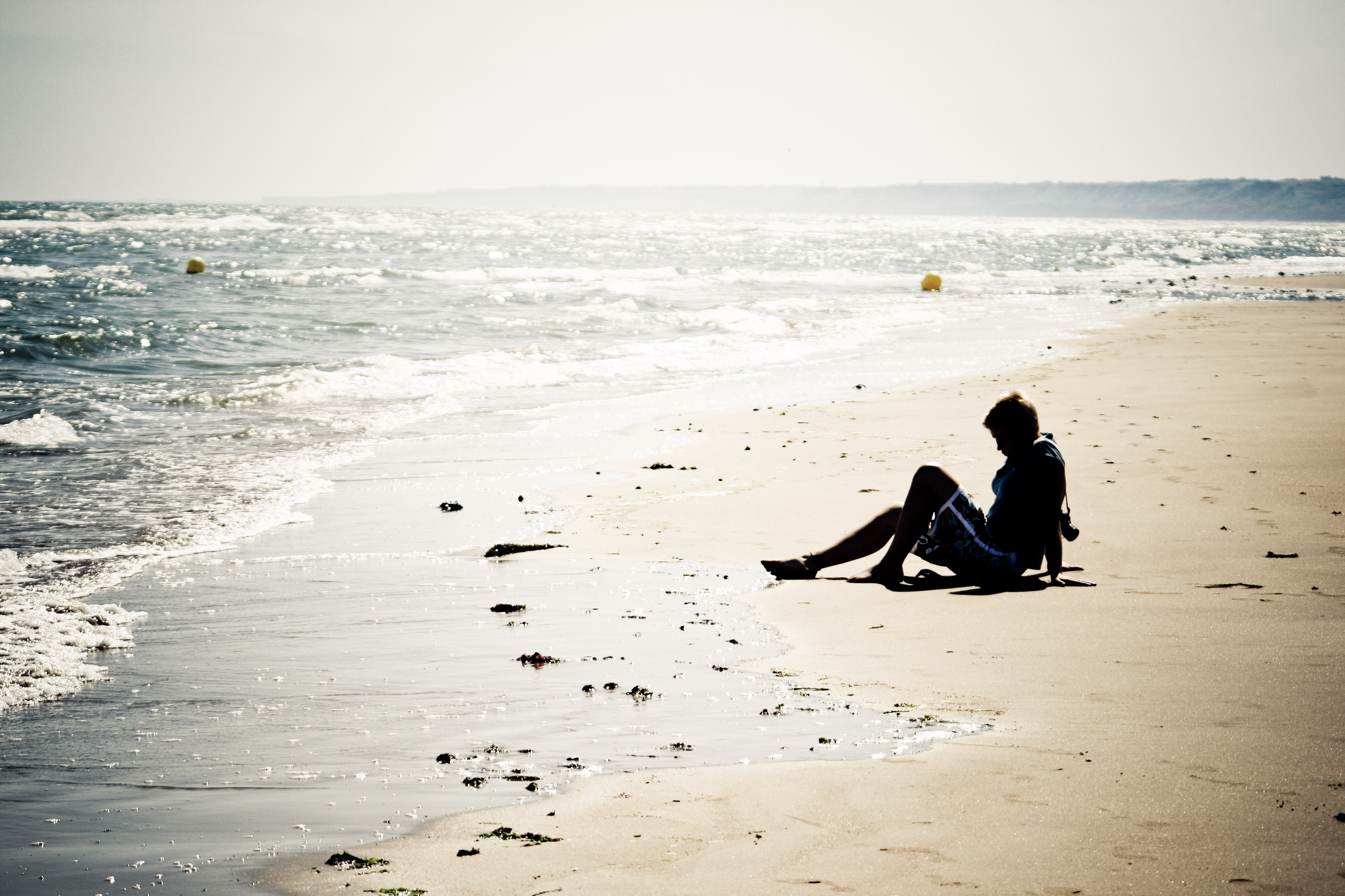 Girl sitting on the beach photo