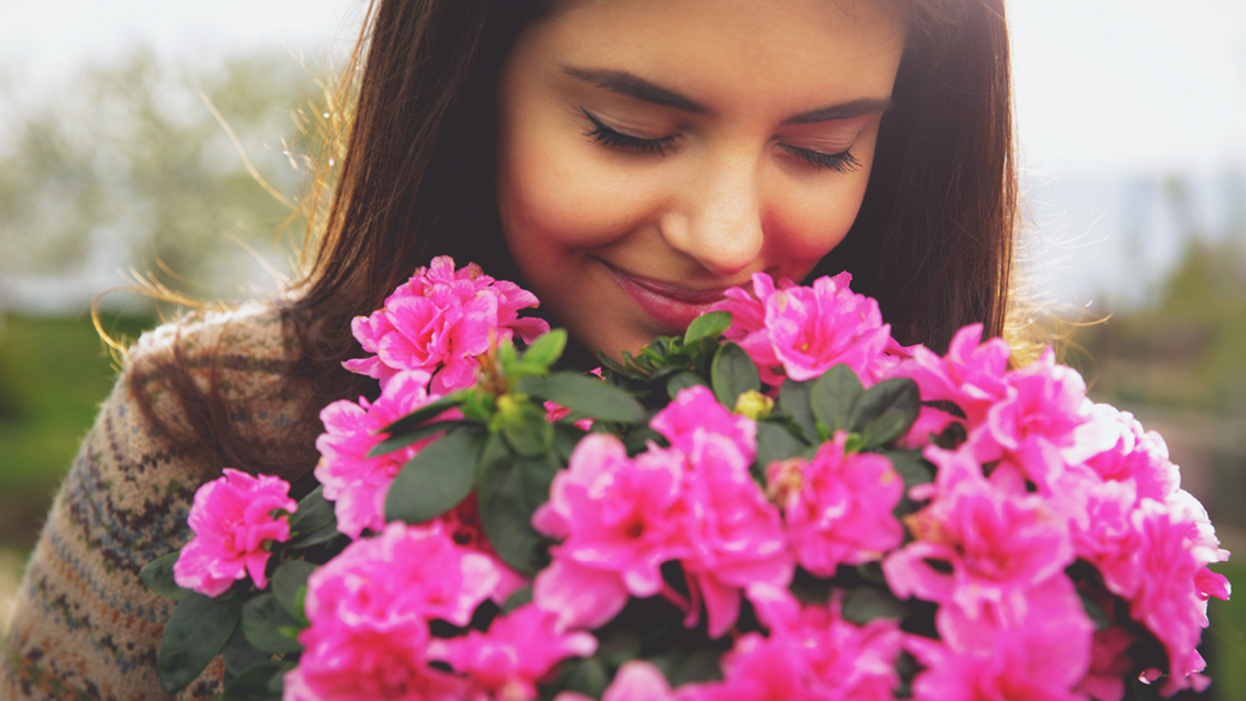 Girl smelling flower photo