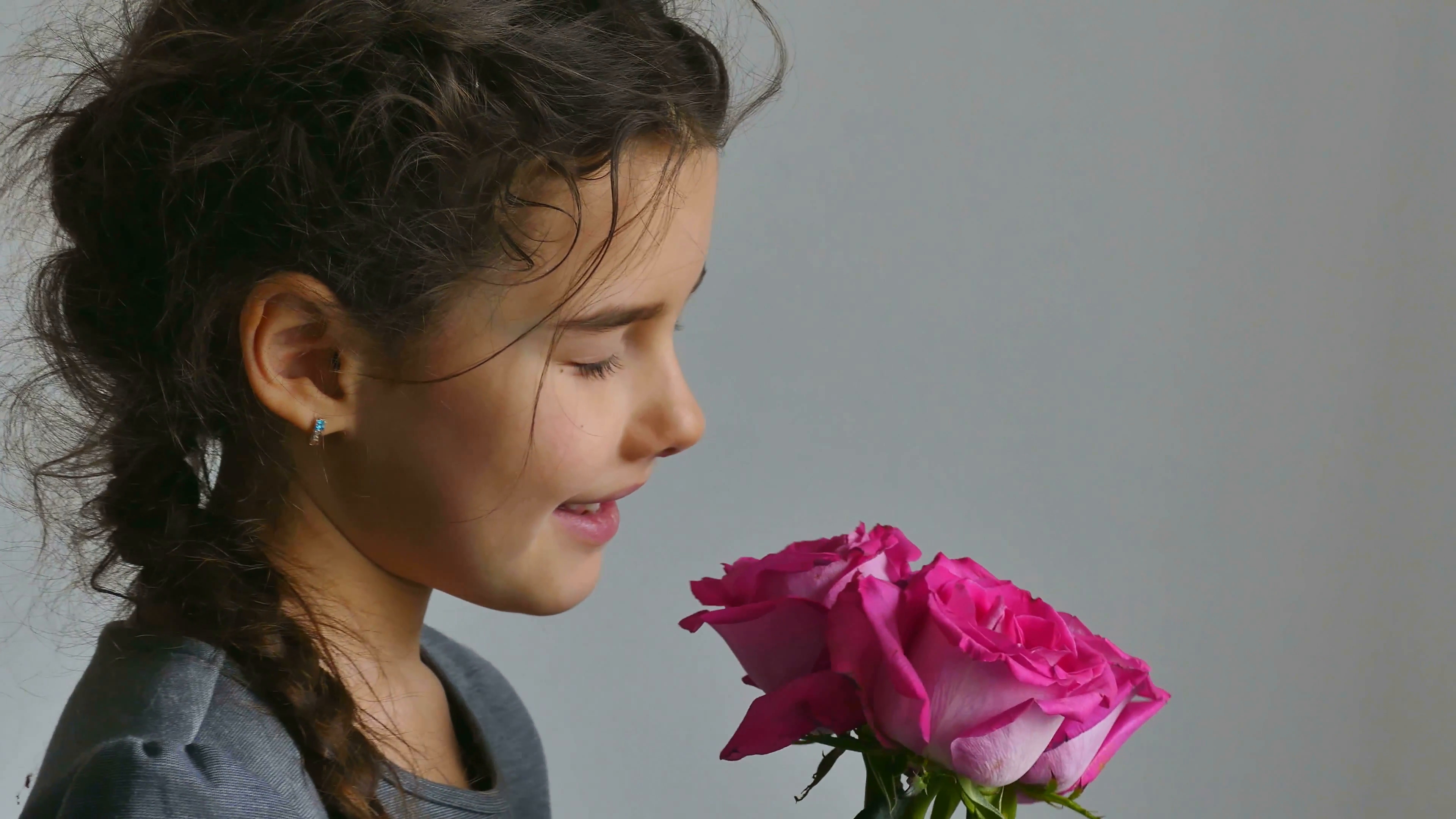 girl teen smelling rose flowers on white background Stock Video ...