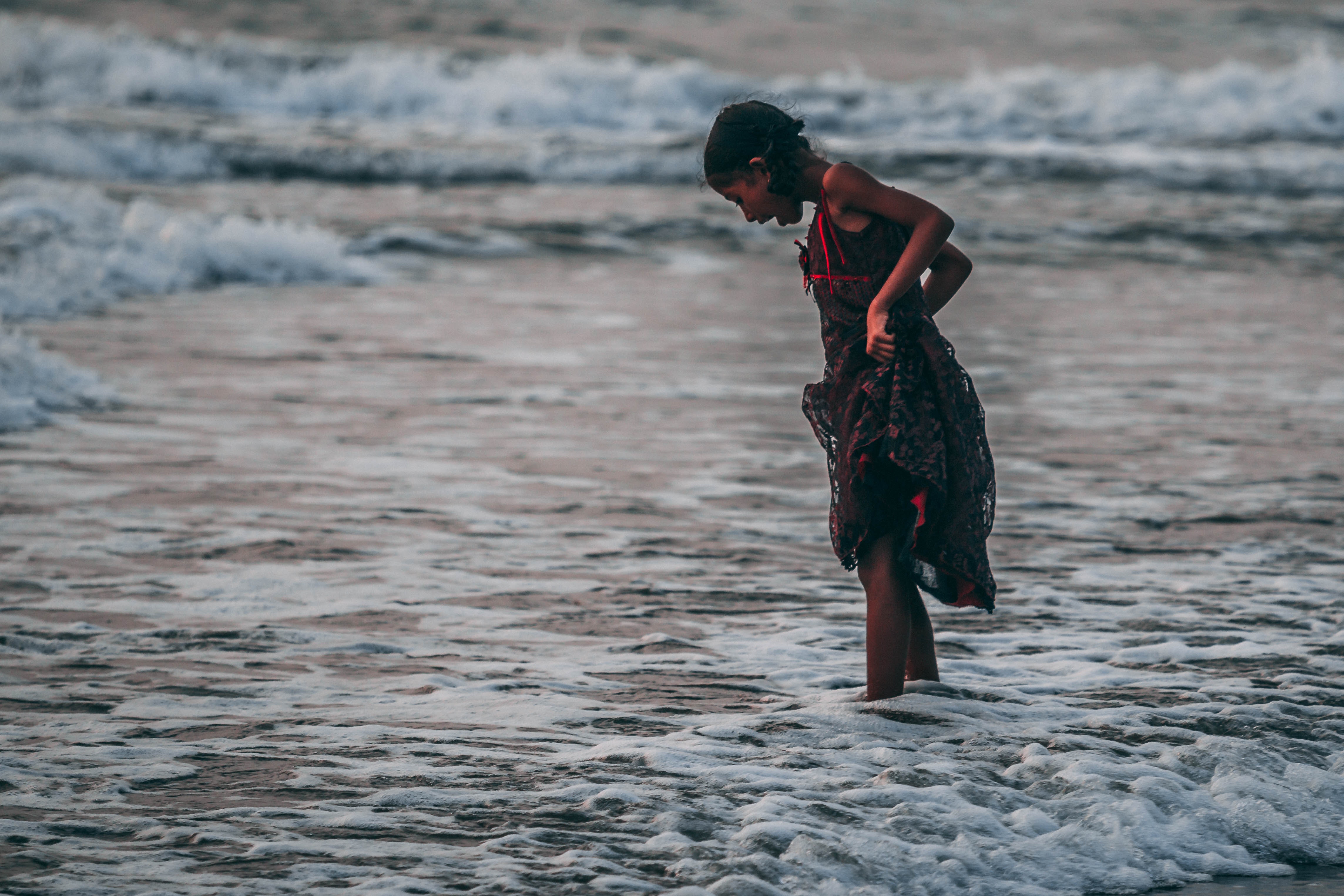 Girl standing on seashore photo