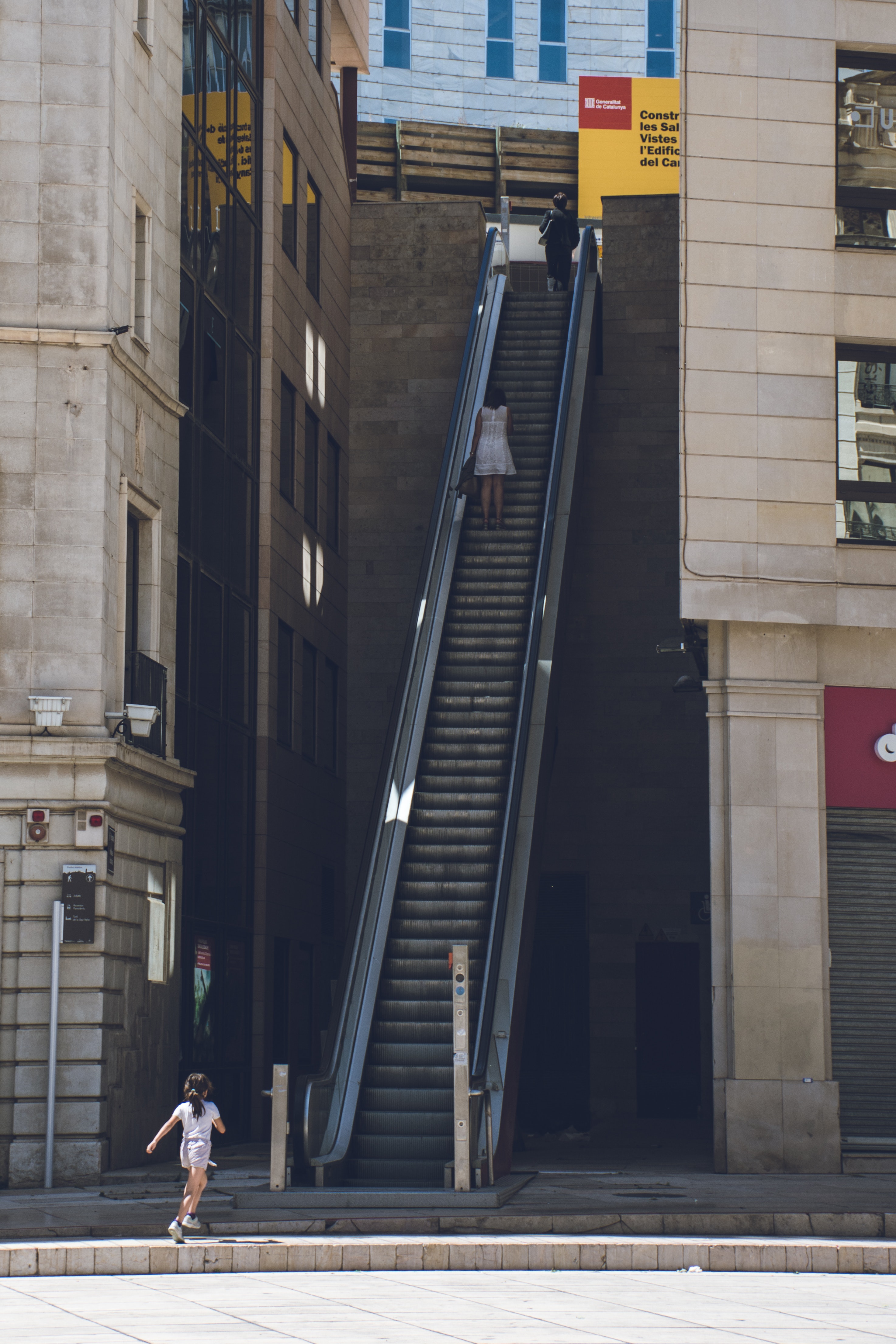 Girl walking towards the escalator photo