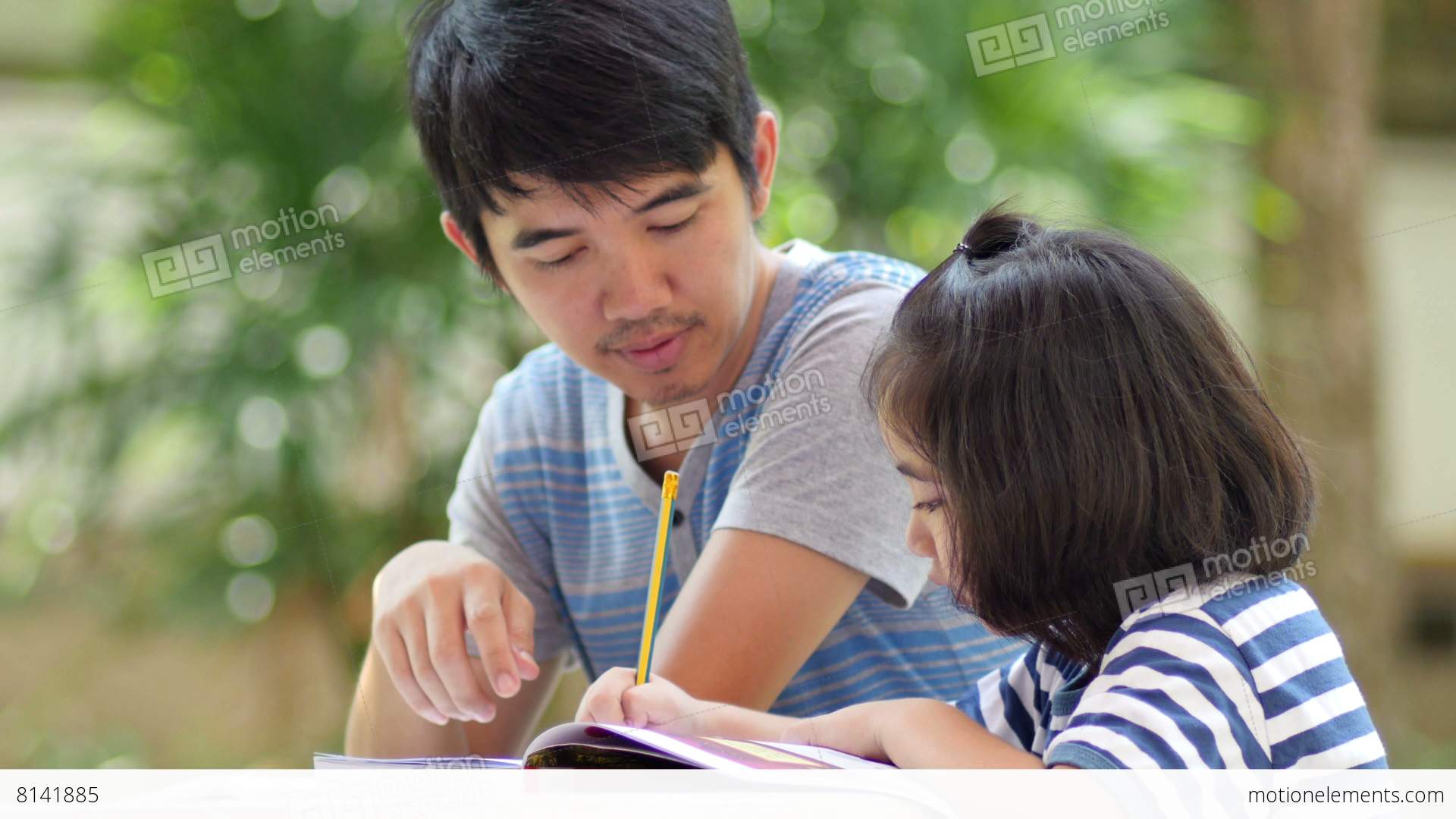 Little Asian Girl With Father Doing Homework On The Table Stock ...