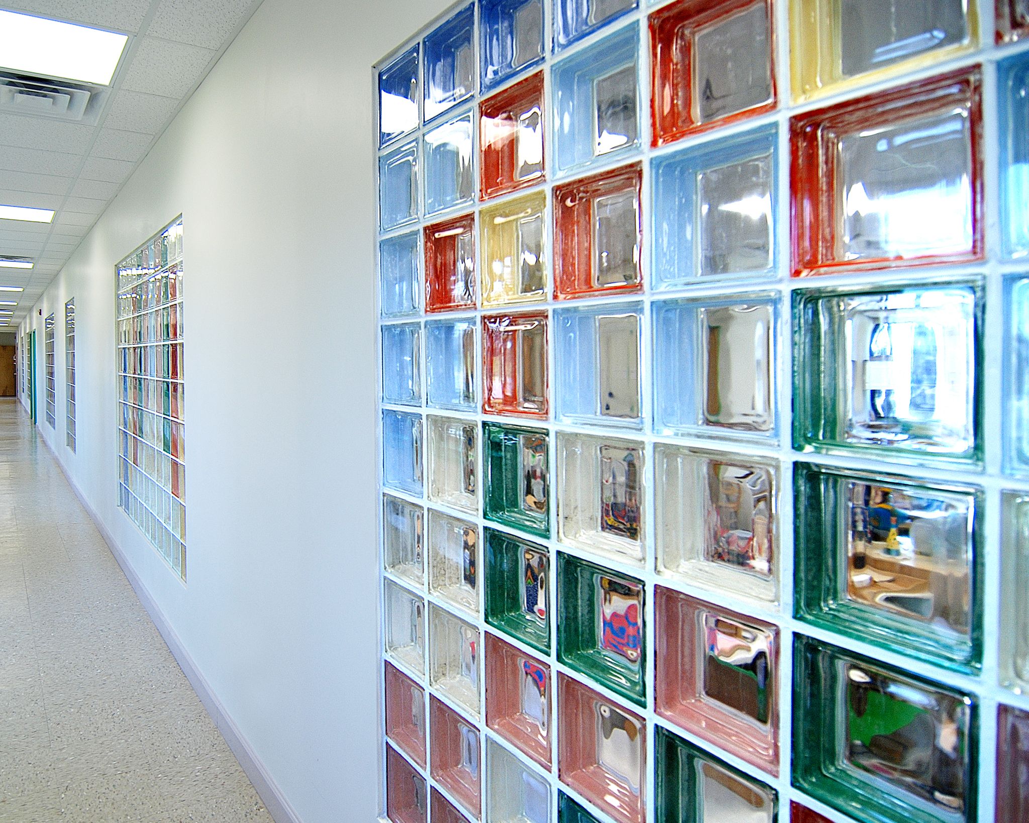 Colored glass blocks wall partition for use between stairwell and ...