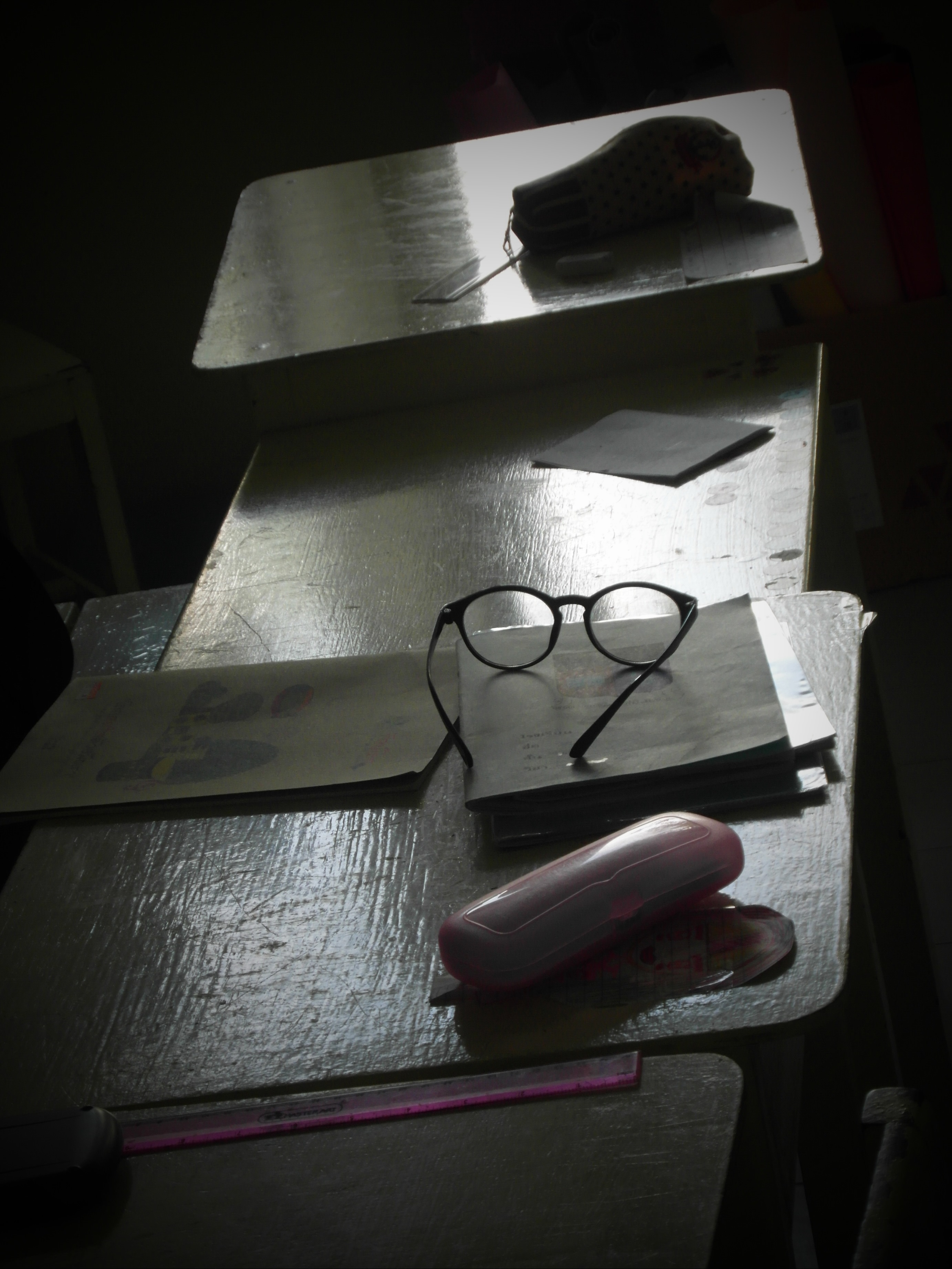Glasses on a school desk photo