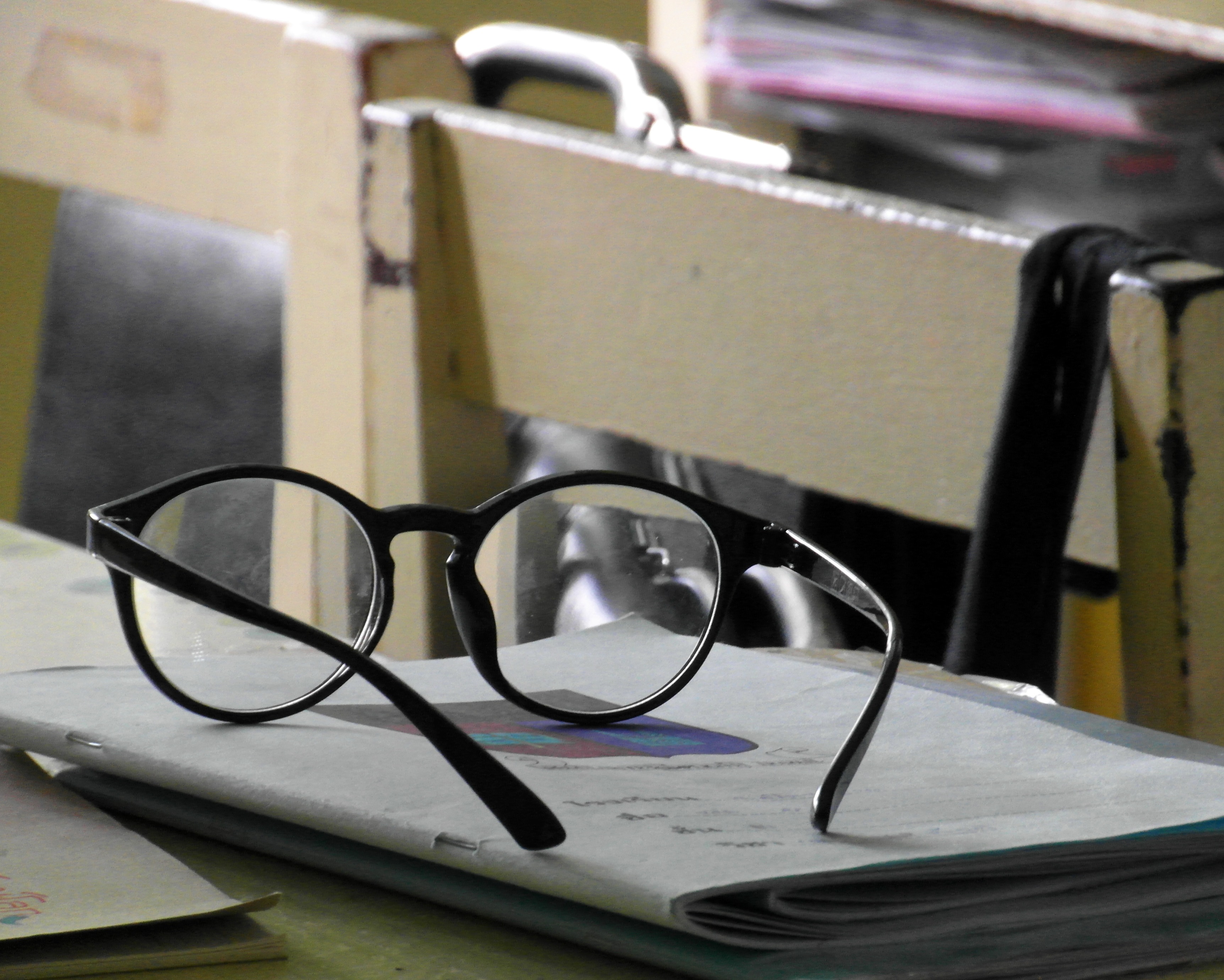 Glasses on a school desk photo