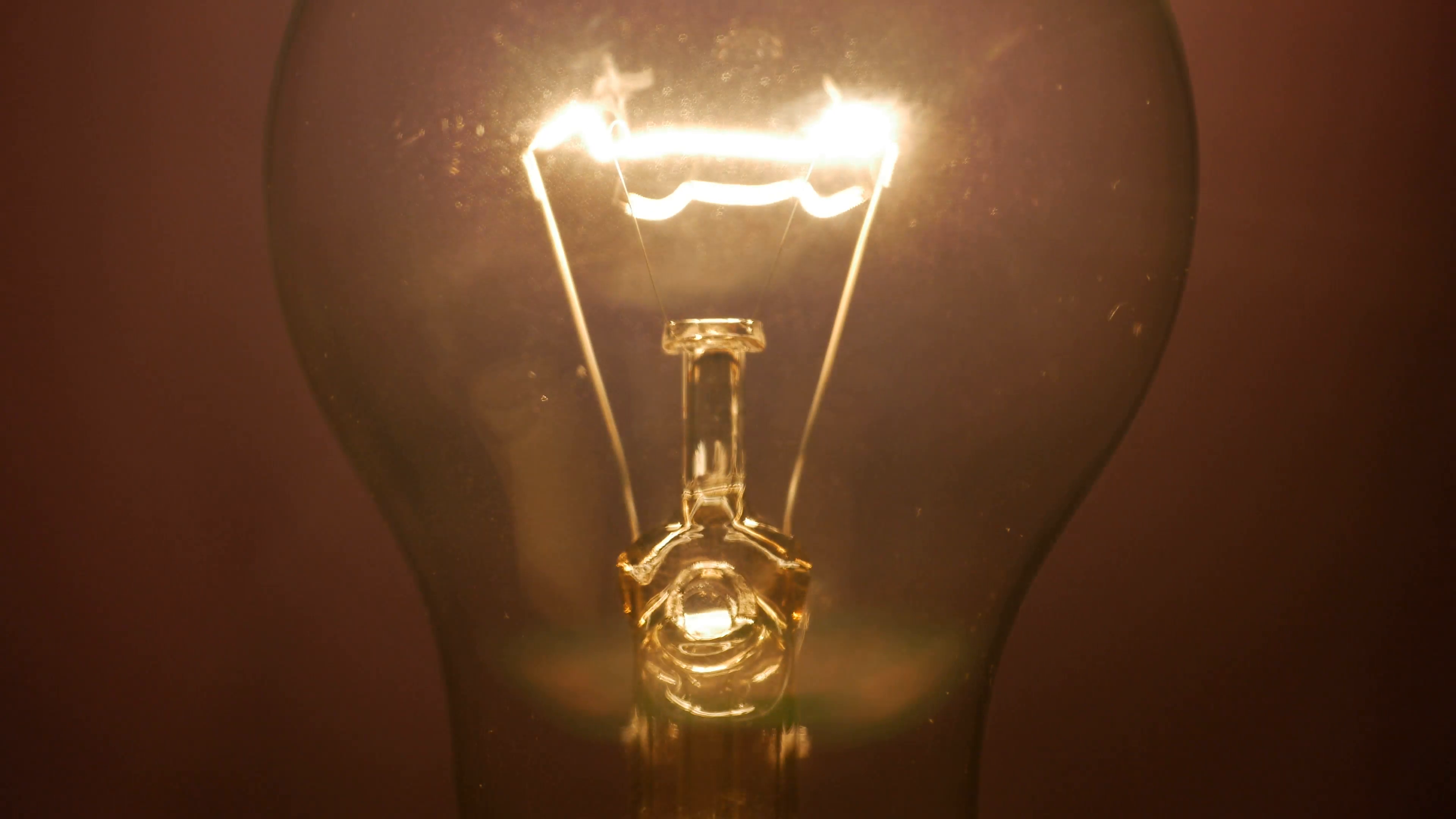 Flashing lamp bulb; light glowing incandescent filament . Detail of ...