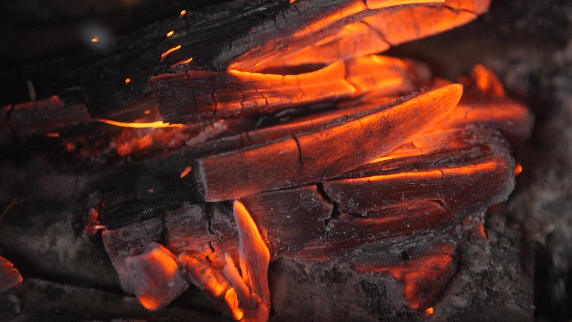 Slow motion - Blowing on burning wood fire, hot glowing flame coal ...