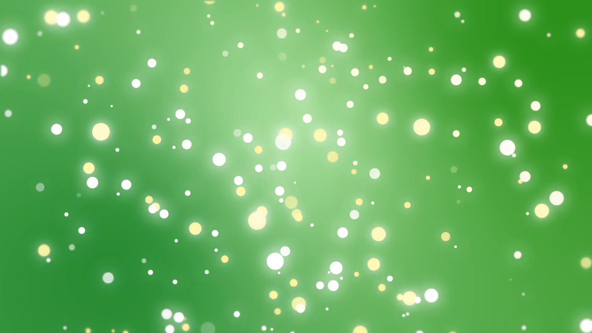 Sparkly gold and silver light particles moving across a green ...