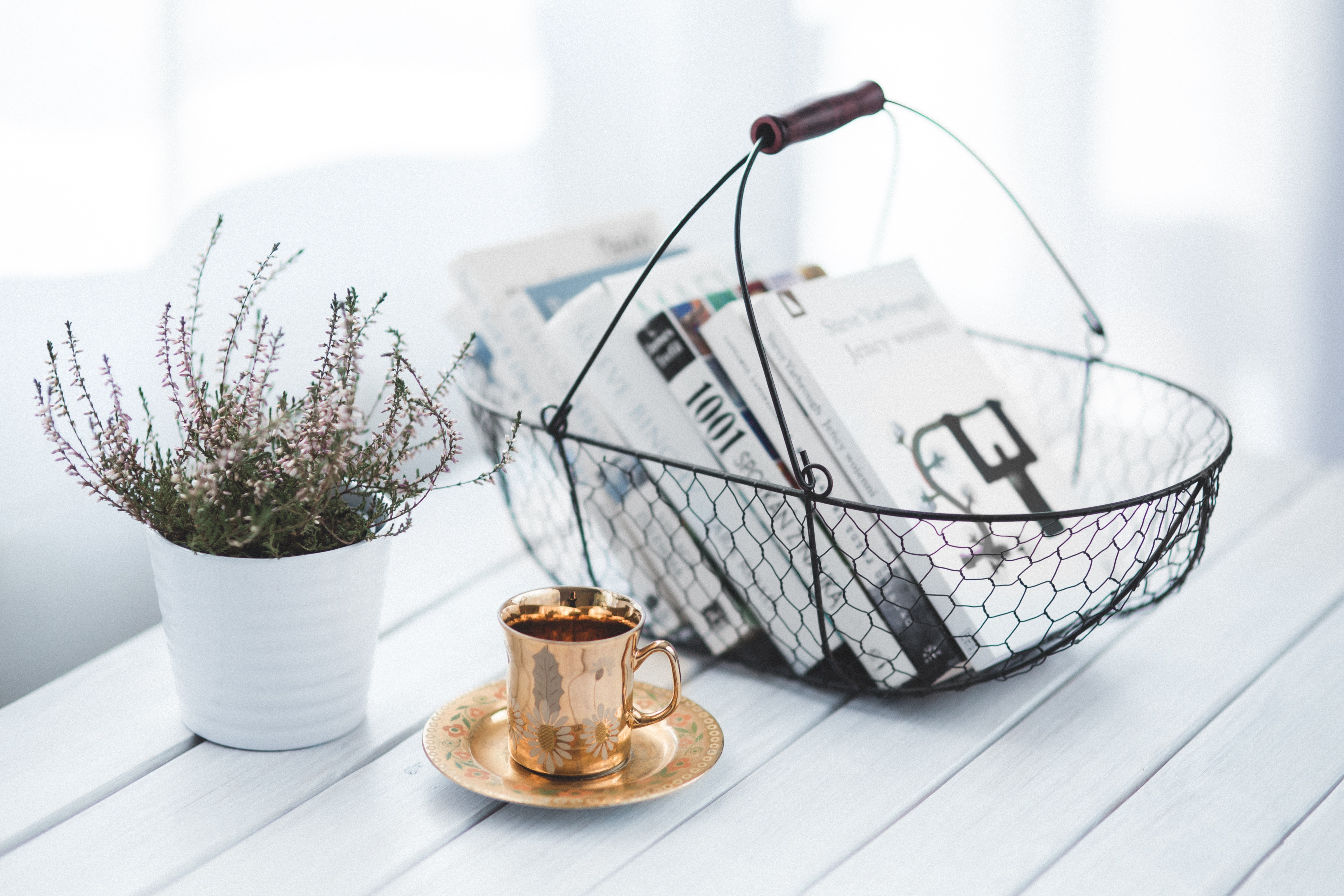 Golden cup and basket with books photo