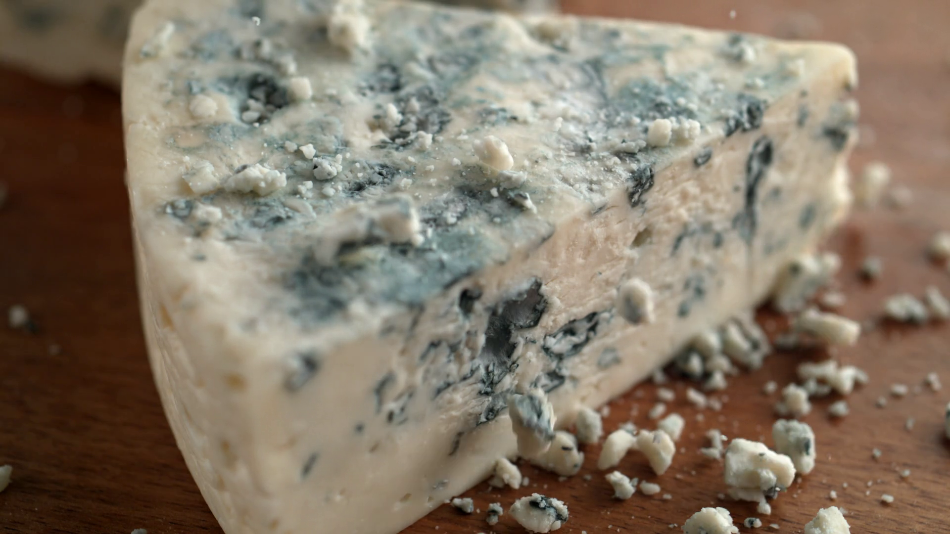 Gorgonzola cheese on wooden board. Shot with high speed camera ...